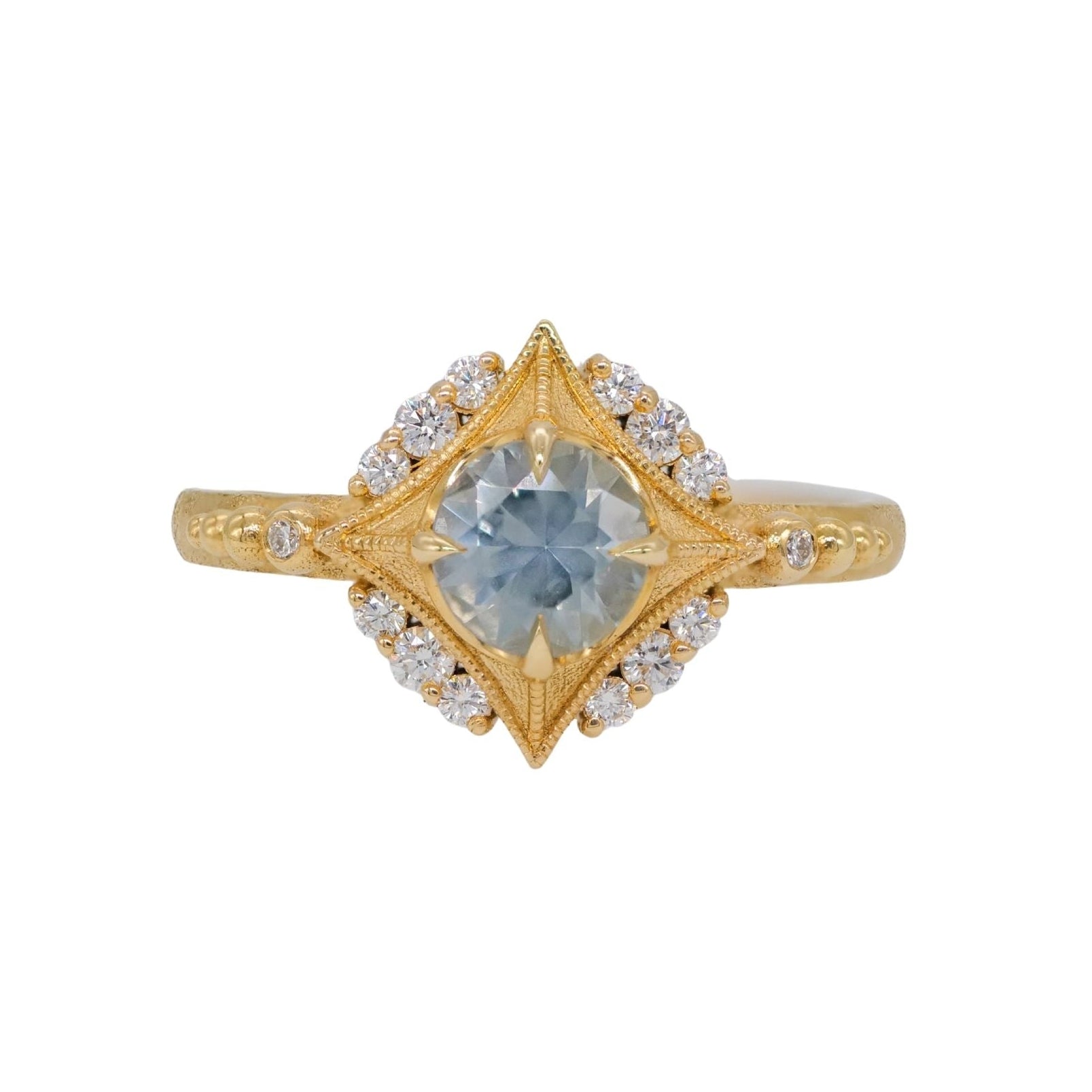 DMD Metal Sabine Nova Ring features a teal sapphire and star-set white accents in a celestial gold design.