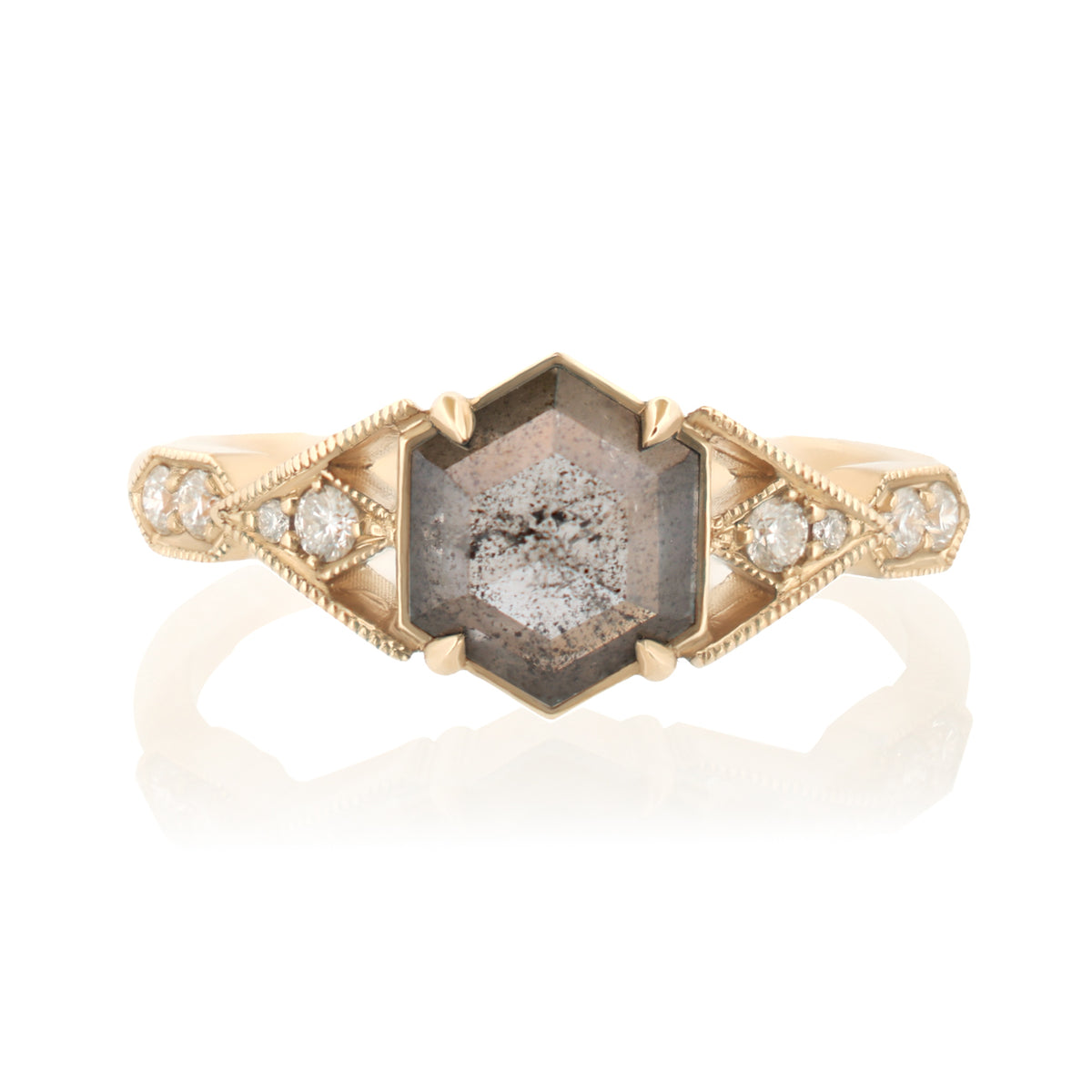A vintage-style gold ring featuring a large hexagonal smoky quartz center stone with tiny inlaid diamonds, flanked by smaller round diamonds on a white background with a soft reflection.