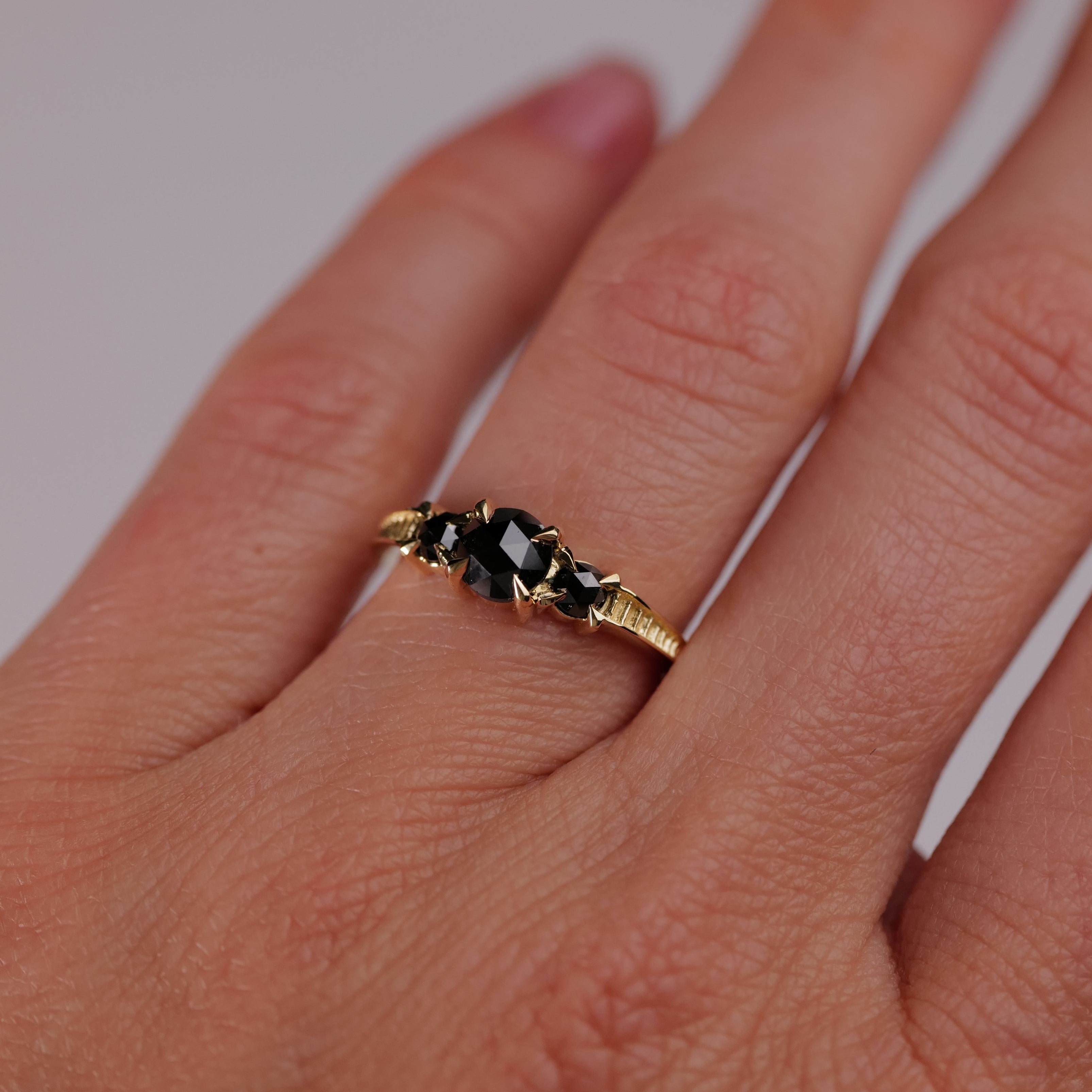 The Fiat Lux Classic 3 Stone Temple Ring—Black Diamond in 18K gold brings bold elegance to any manicured hand.