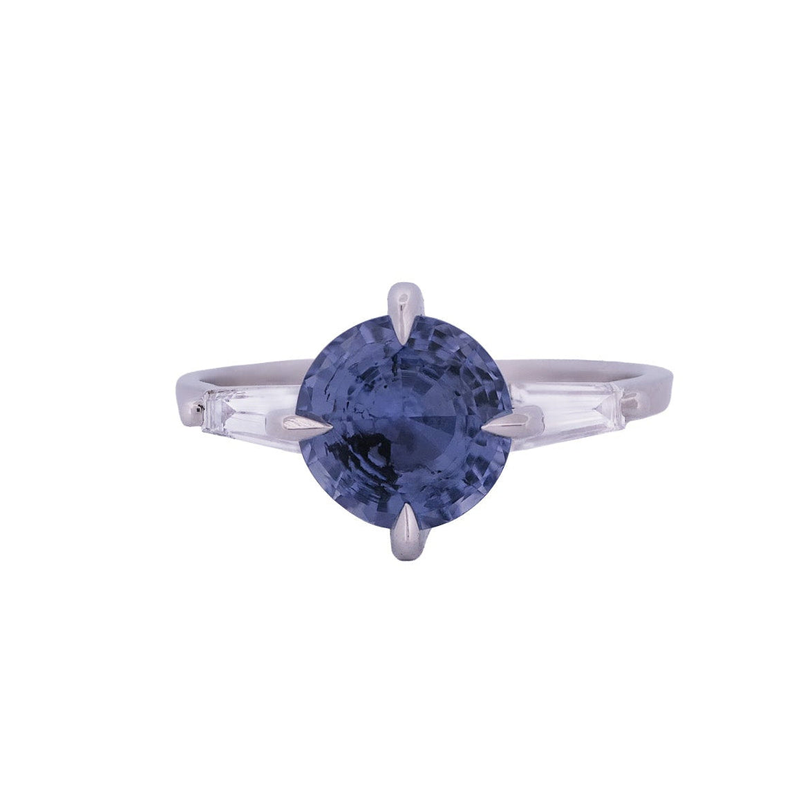 Fiat Lux Grande Calliope: 2.05ct periwinkle sapphire ring with diamond baguettes on each side.