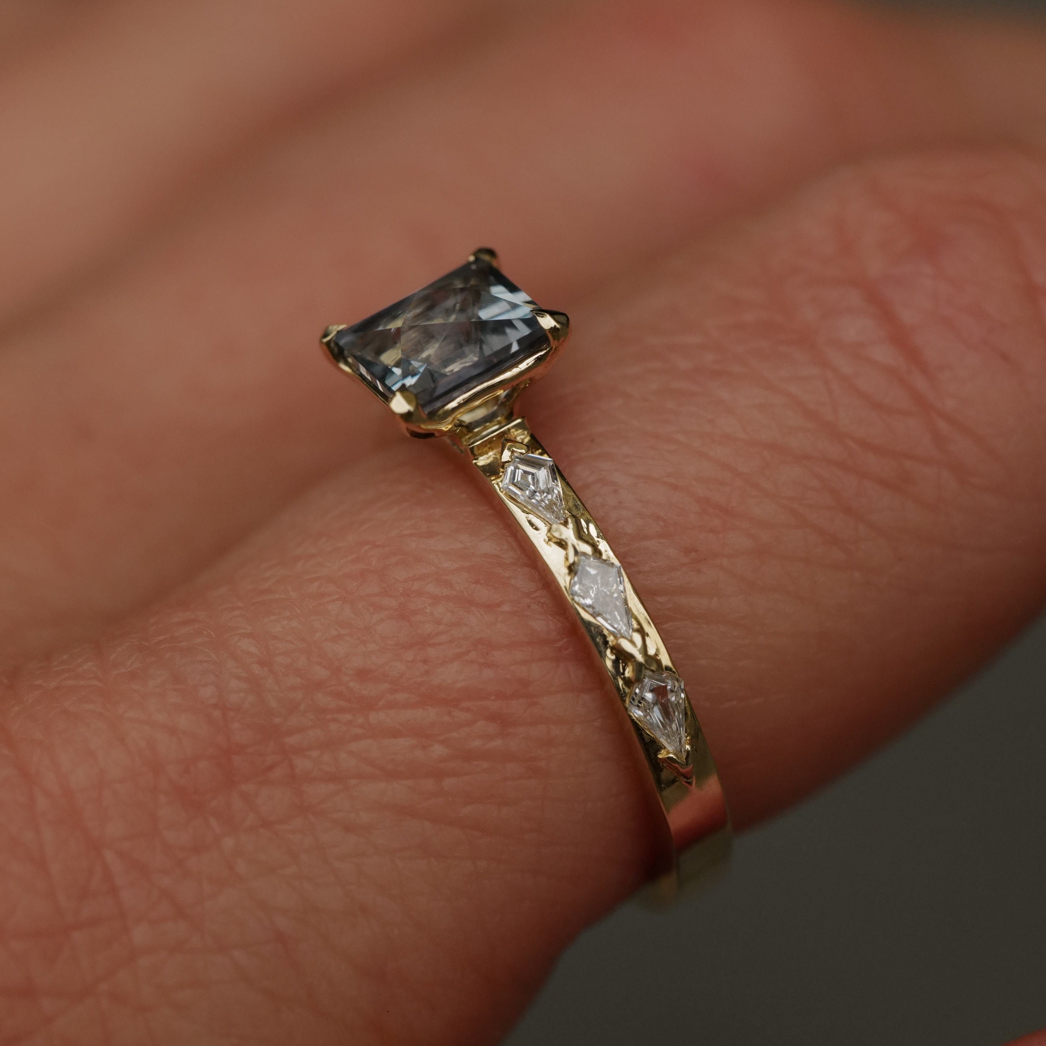 The Fiat Lux Classic Theia Ring features a 1.41ct aqua sapphire and dazzling kite diamonds on a finger.