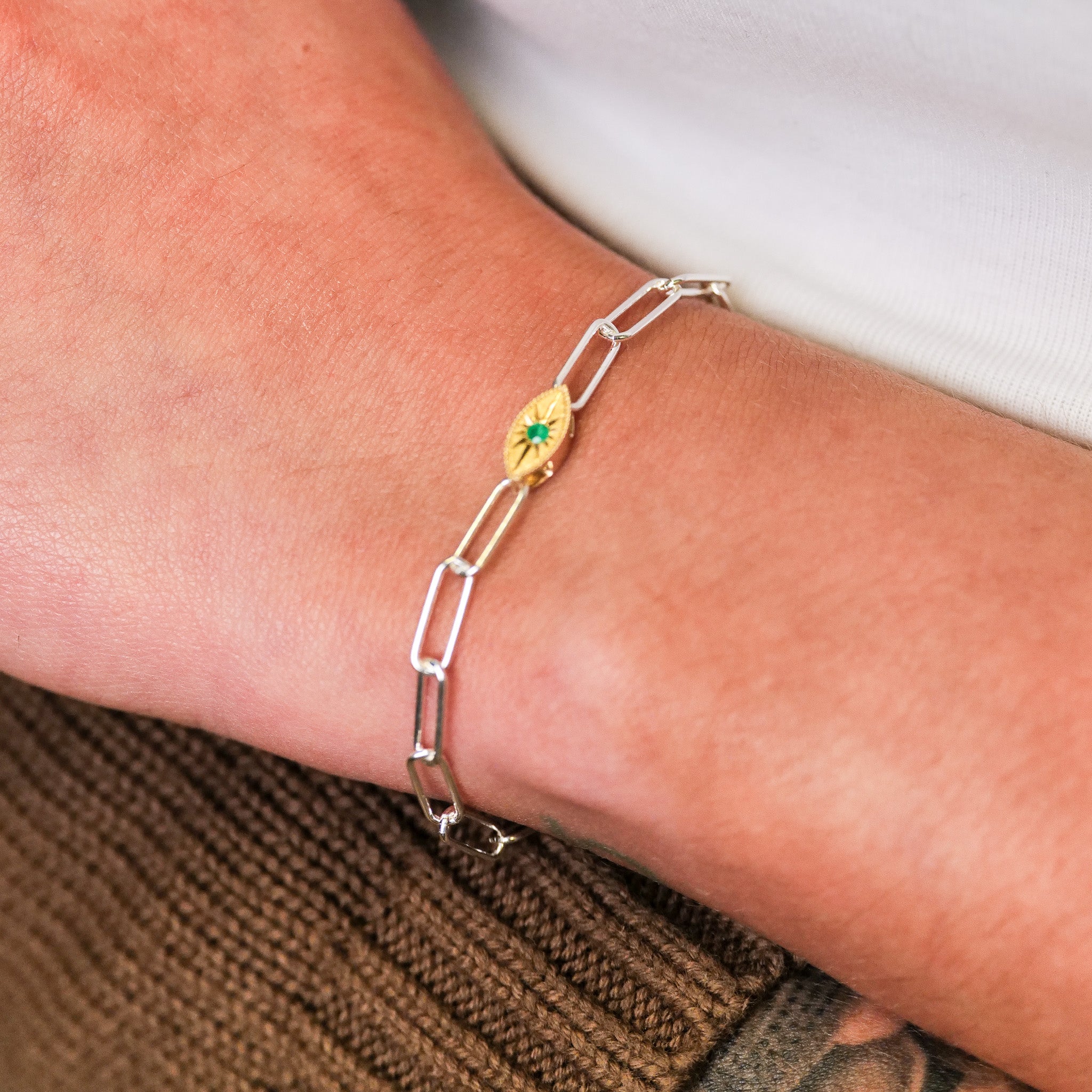 The Grande Mati Bracelet (G) by Fiat Lux is a silver chain with a 14K gold green eye charm for minimalist jewelry lovers.