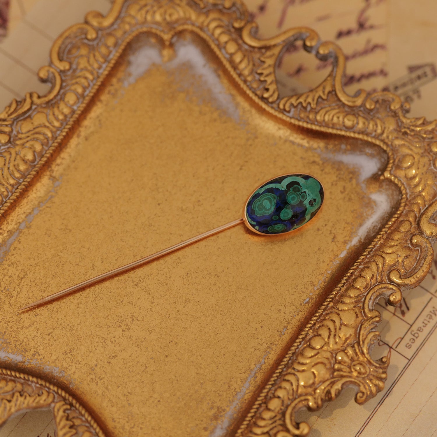The Vintage Antique Azurmalachite Stick Pin with a green-blue oval stone rests on an ornate tray.