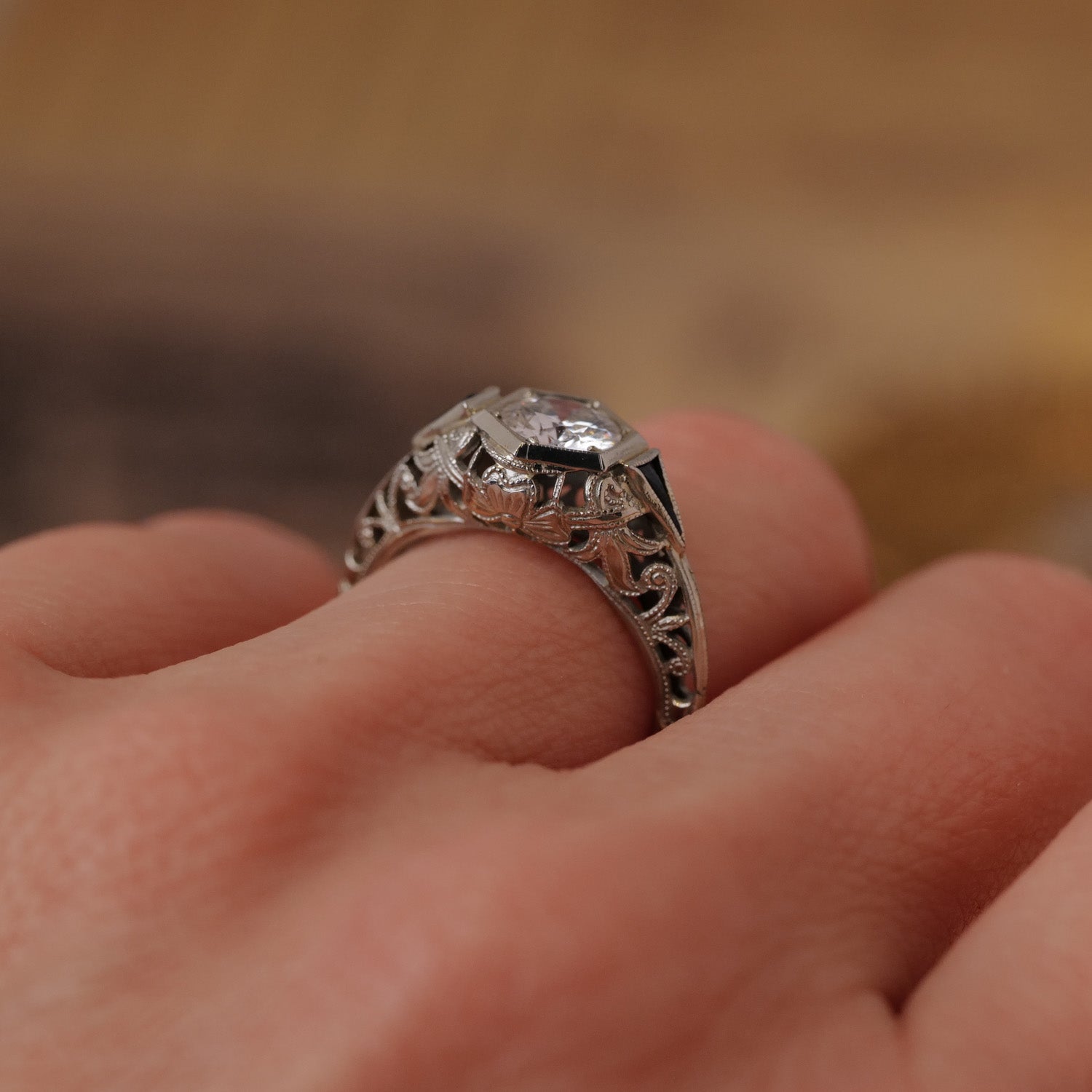 A Vintage Art Deco Botanical Hexagon Ring with an Old European Cut diamond sparkles in a close-up shot.
