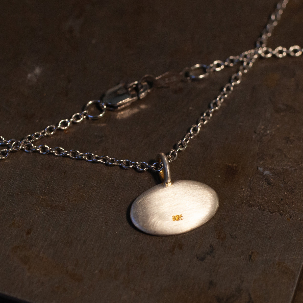 Blue Blue Driver’s Engraved Moth Necklace shines elegantly—an eye-catching talisman on any surface.