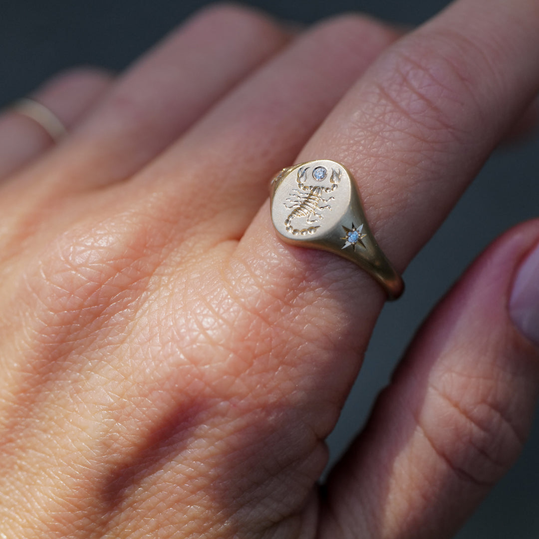 Blue Blue Drivers Scorpion Signet Ring - Diamond: a 14k gold Scorpio ring with engraved scorpion and diamond.