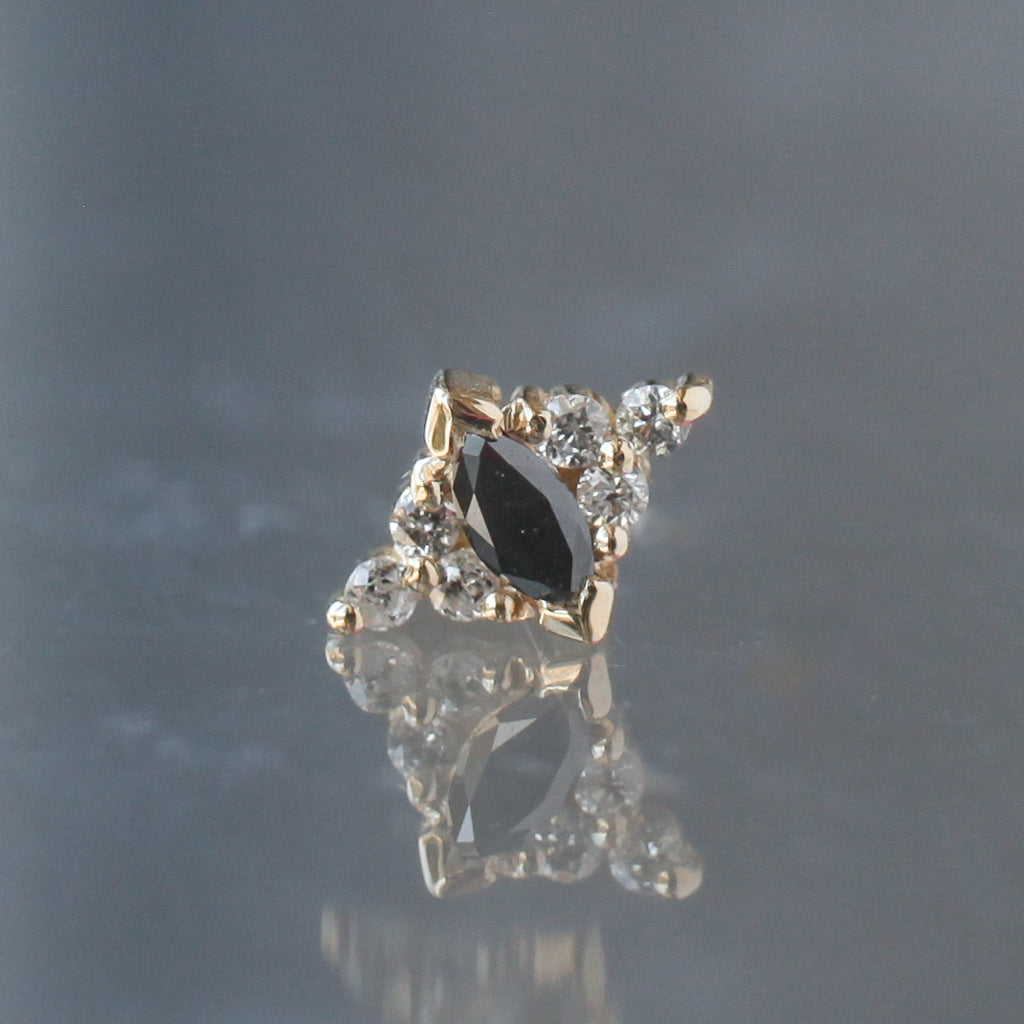 BVLA Embrace Marquise gold stud earring featuring a central marquise-cut black stone surrounded by small clear stones.