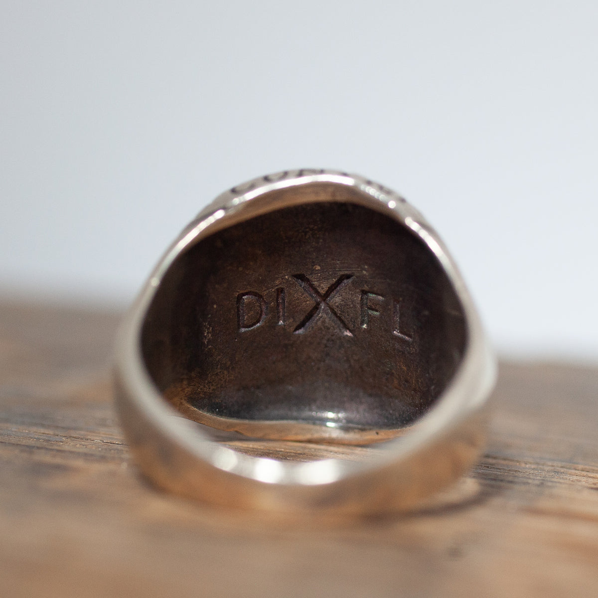Close-up of a Digby & Iona Honest Abe Signet Ring with DIXFL engraved on the inner band.