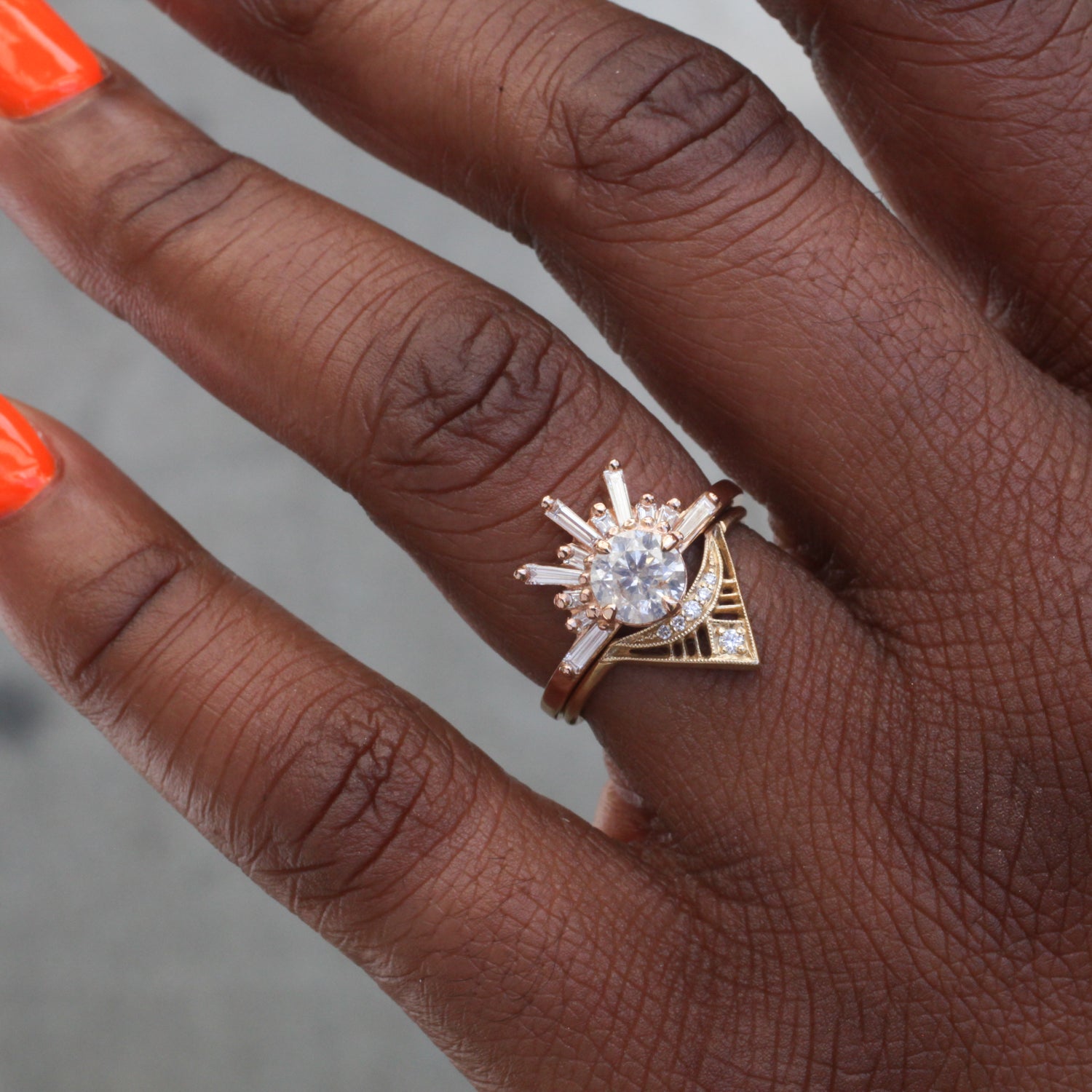 A hand with orange nails wears the DMD Metal Zilfa Ring - Classic, a 14K gold piece with bold milgrain latticework.
