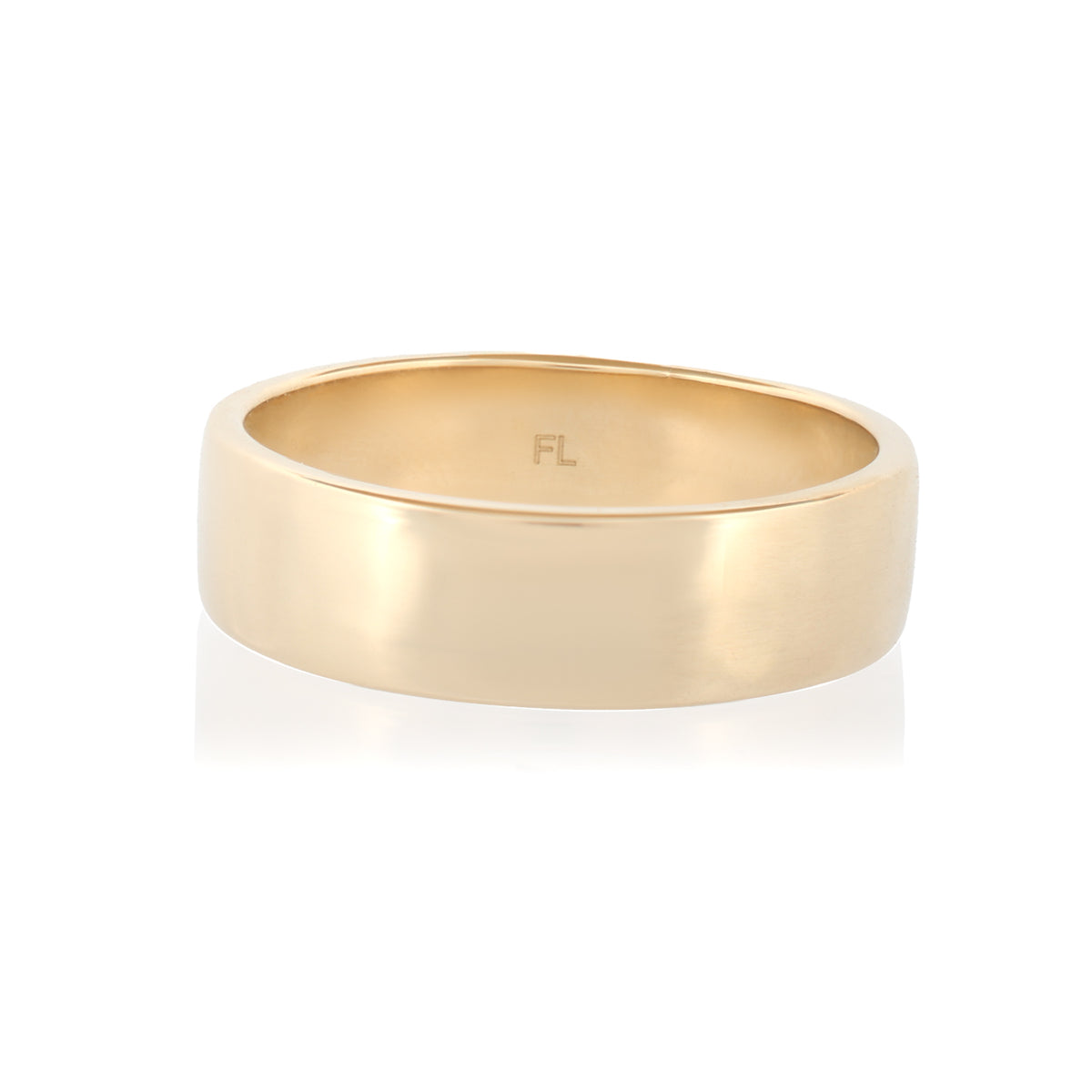 A gold-toned Classic Flat Band (6mm) ring with the letters FL engraved on the inside.