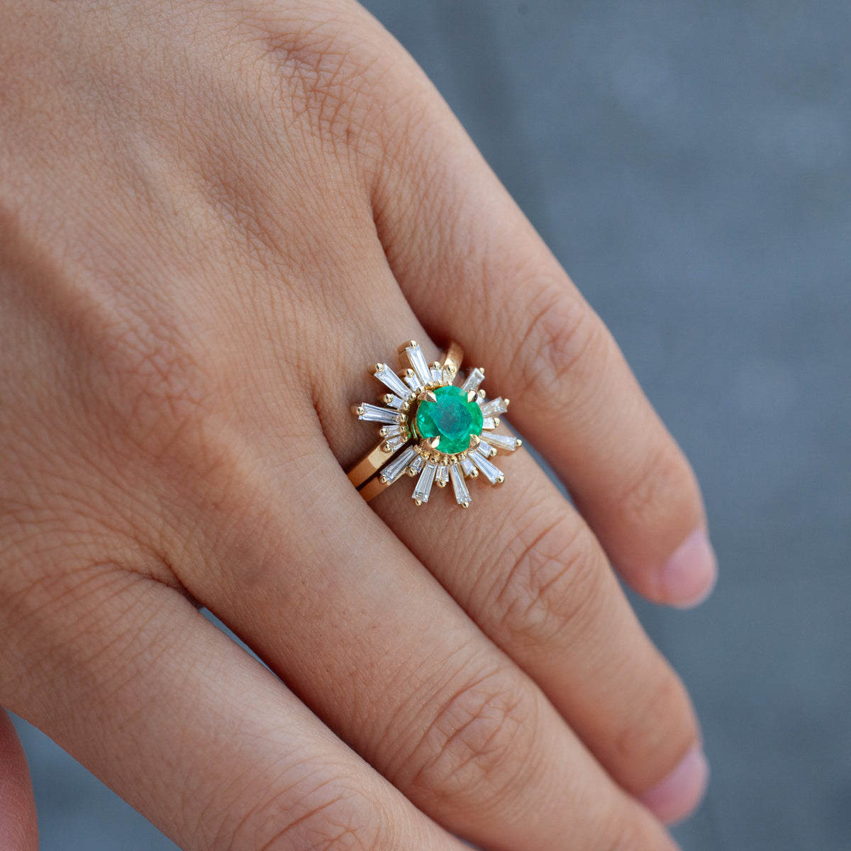 Fiat Lux Grande Demi Feu - Emerald Cushion (1.29ct) ring: a cushion-cut emerald in a diamond sunburst on a gold band.