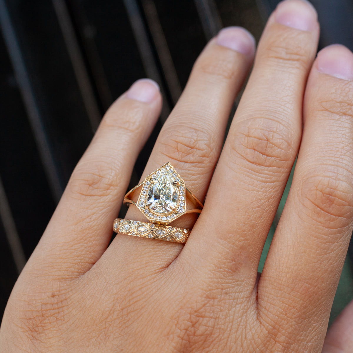 Serpentra Ring - Marquise Diamond in 14k gold with a matching diamond-encrusted band on a finger.