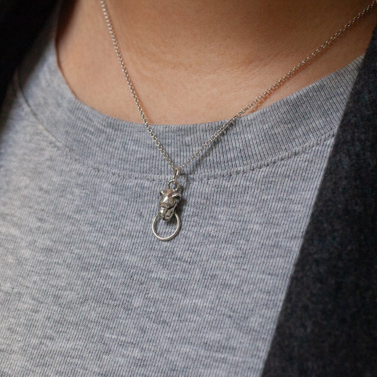 Sacred Order Potentia Door Knocker Necklace: a dainty silver lion head pendant holding a ring in its mouth.