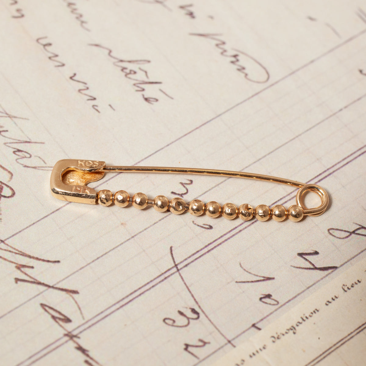 A 14K gold Vintage Beaded Safety Pin featuring a row of small, round beads along the bottom wire.