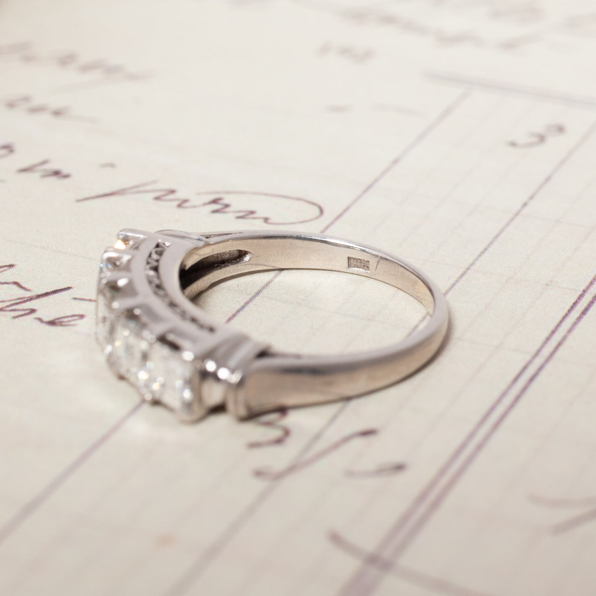 A Vintage Carré Cut Diamond Band - 4.5mm, a vintage platinum ring set with five square-cut diamonds.