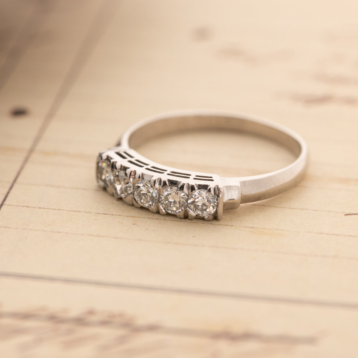 A Vintage Diamond Band Ring featuring five old euro cut diamonds in a metal setting.