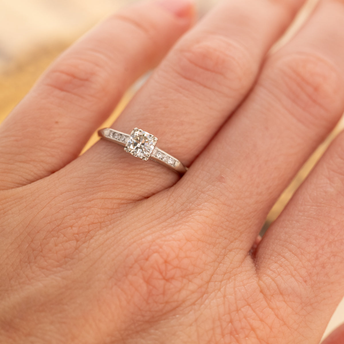 A Vintage Old European & Single Cut Diamonds Ring in 14k white gold with a round diamond and channel-set side diamonds.