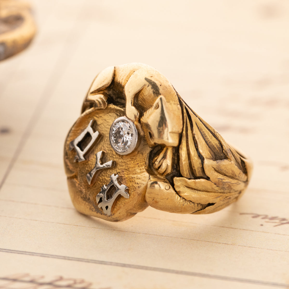 Vintage Panther with Diamond Heavy Signet 14k gold ring with a panther relief, a set diamond, and metal lettering.