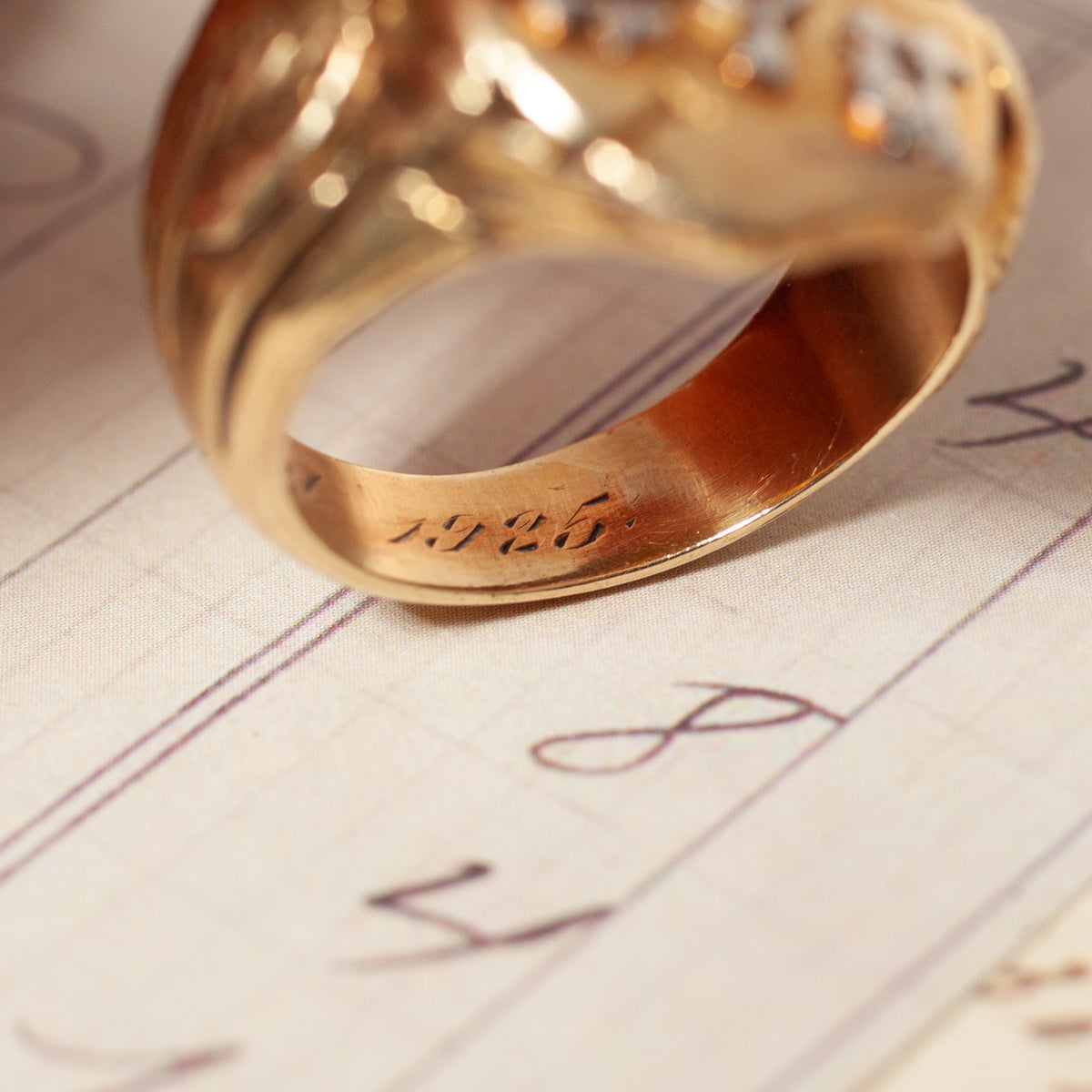 Vintage Panther with Diamond Heavy Signet ring on lined ledger paper, engraved with 1925 on the inner band.