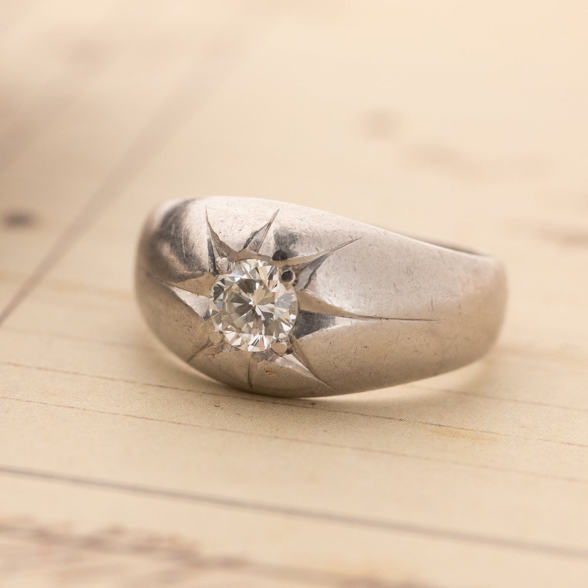 Vintage Star Set Bombe Ring in platinum PT900 featuring a vintage diamond set in a star-shaped engraving.