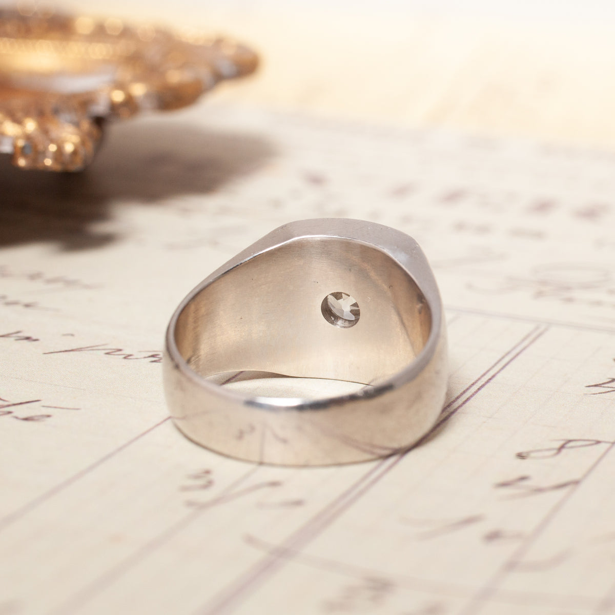 Vintage Star Set Square Signet ring in platinum with a small star-set Old European Cut diamond on the inner band.