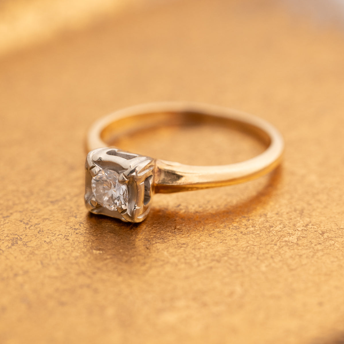 Vintage Two Tone Diamond Ring featuring a single round stone in a square setting with gold and silver tones.