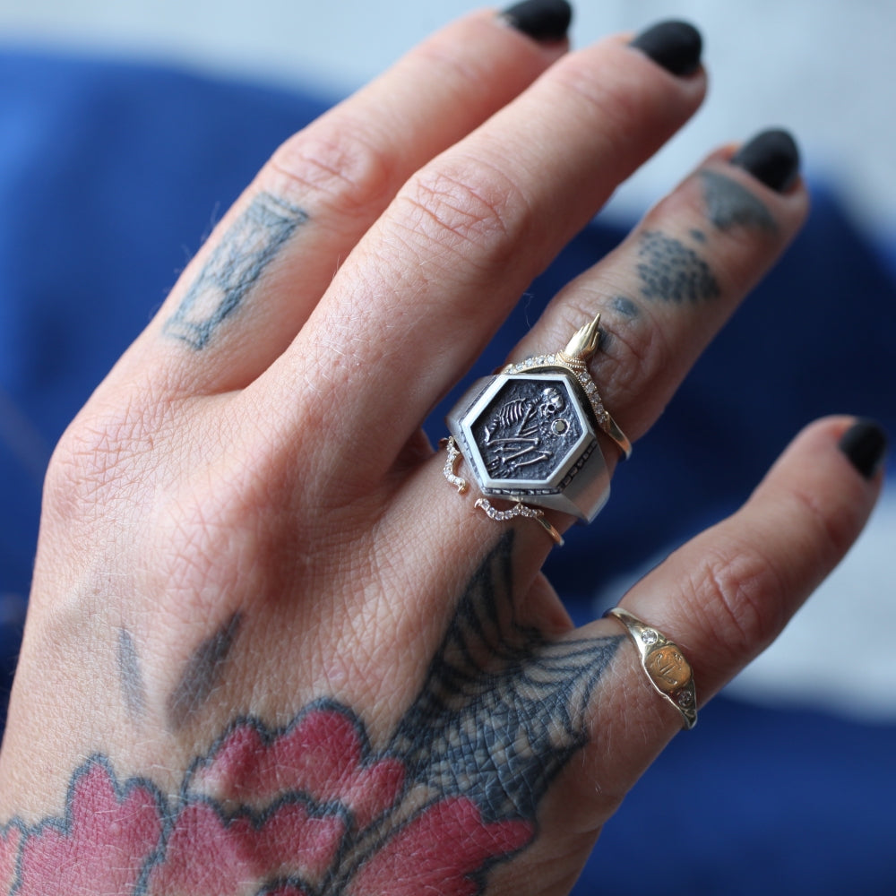 The Shallow Grave Ring by DMD is shown in the middle of a two ring stack