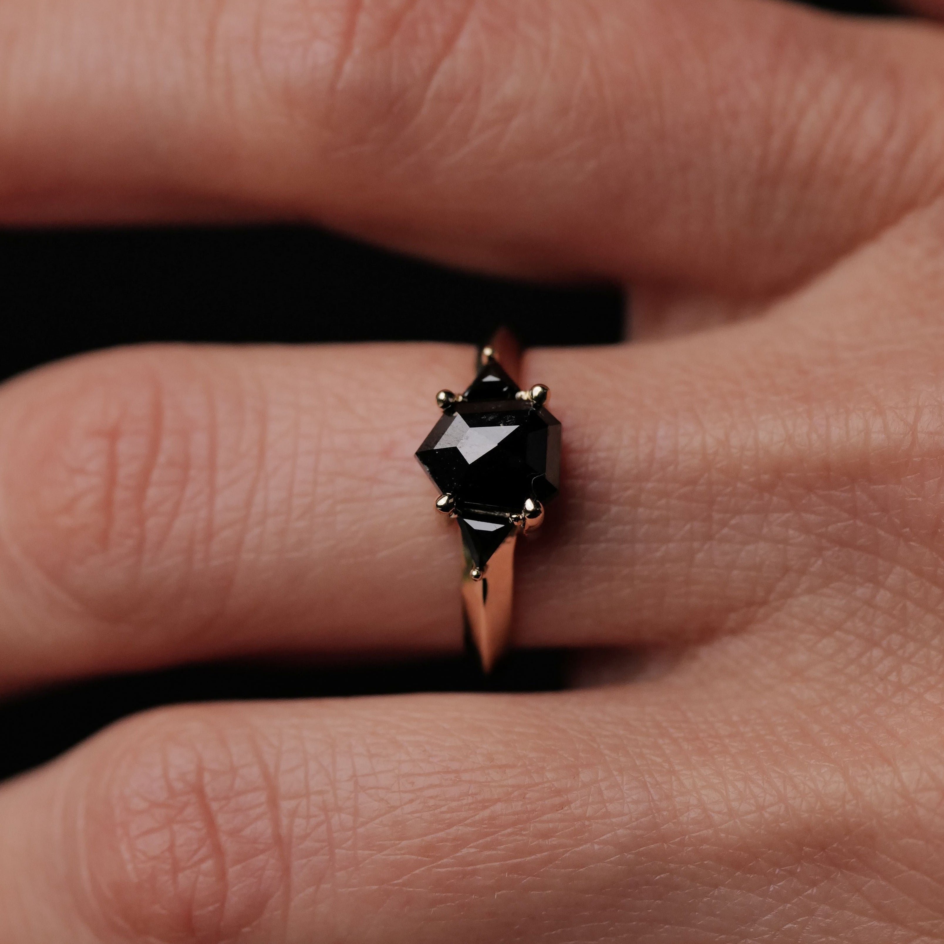 A close-up of a hand wearing Digby & Ionas Petite Caliburn - Black Diamonds (1.46ct) ring.