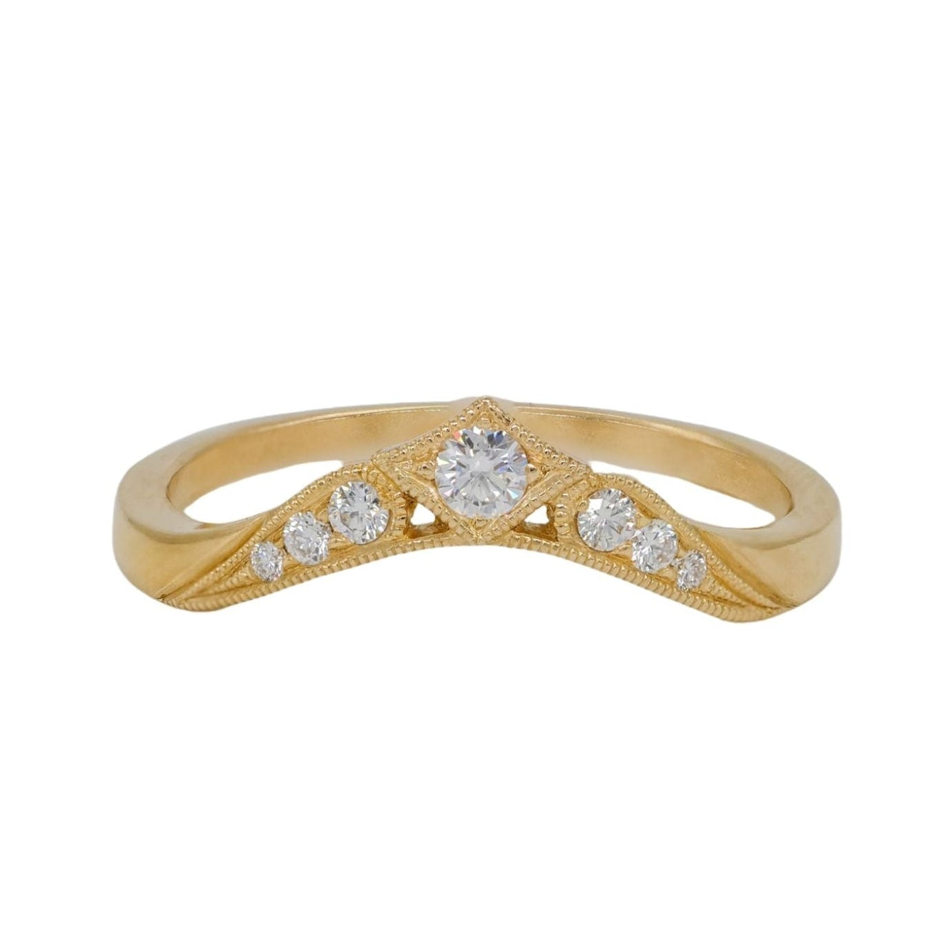The Morgan Ring by DMD Metal features 14K gold with a central diamond and smaller diamonds on a textured v-shaped band.