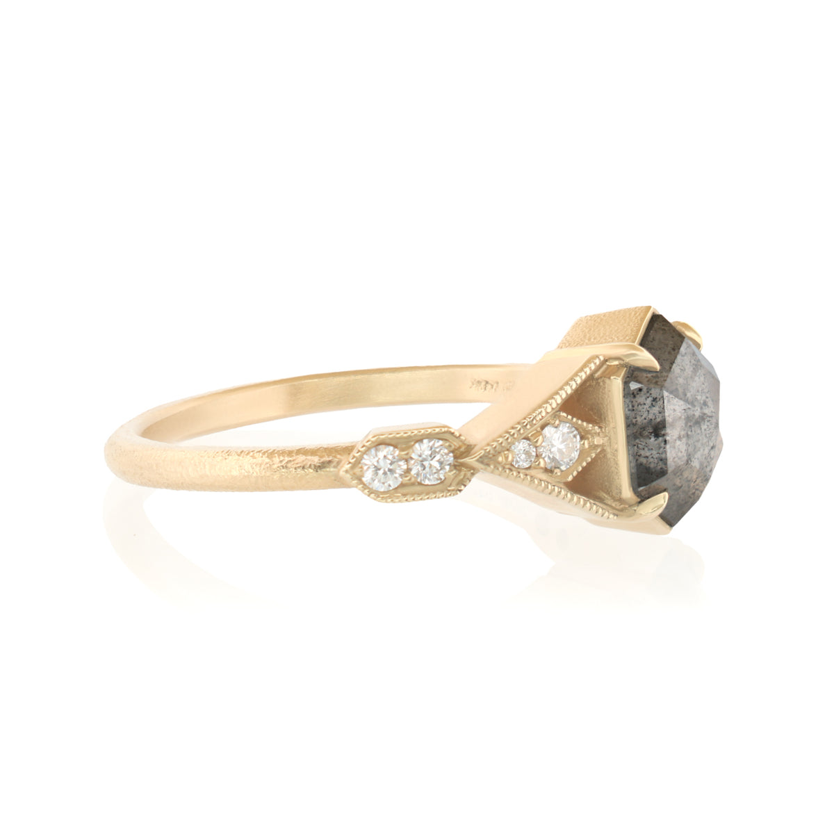 A yellow gold ring featuring a large, rough-cut gray gemstone in a triangular setting, accented by three small round-cut diamonds on the band, shown against a plain white background.