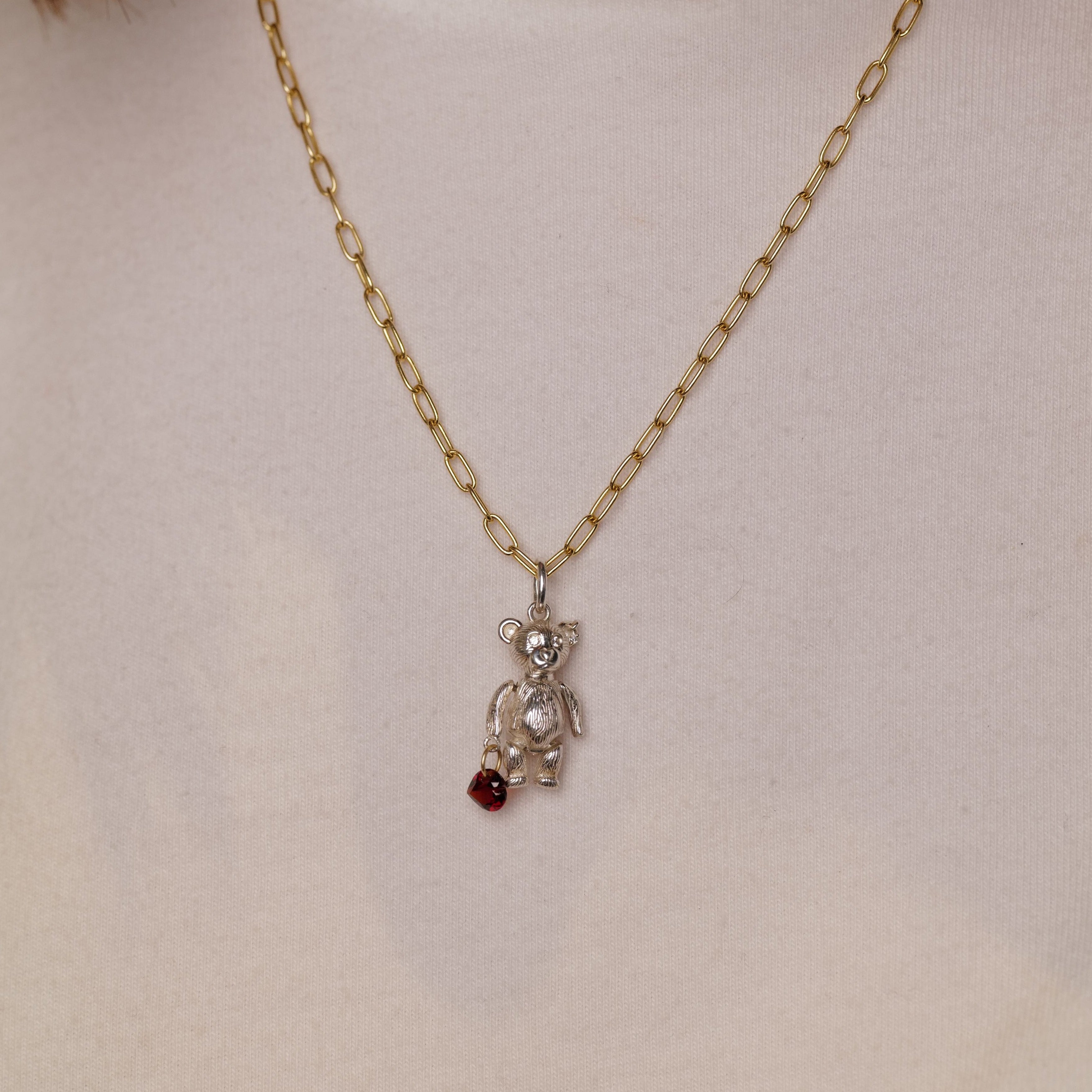 The Fiat Lux Mr Teddy Charm (S) is a gold chain necklace with a vintage teddy pendant and red gem in sterling silver.