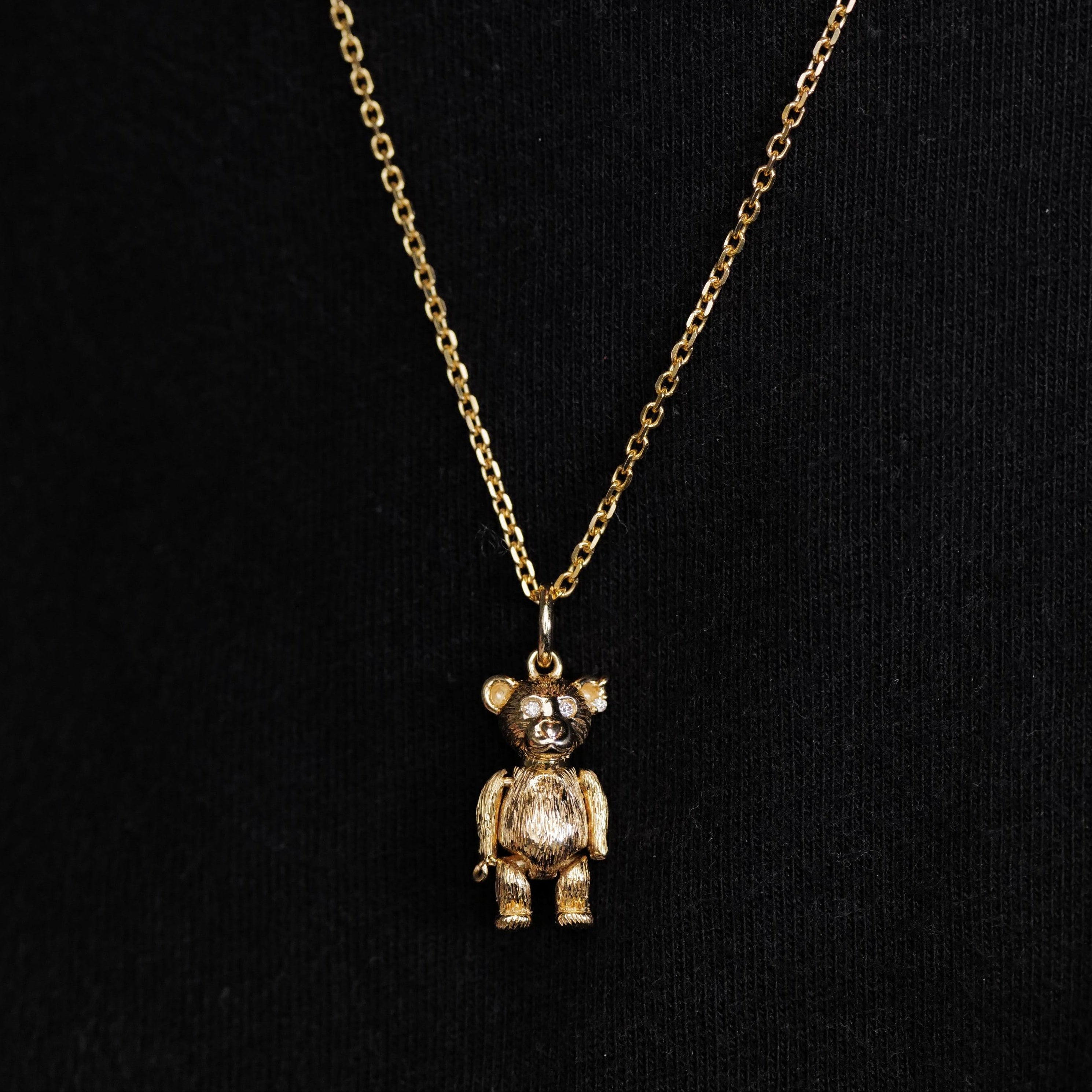 Fiat Lux Mr Teddy Charm (G) pendant necklace in 10K gold shown on a black background.