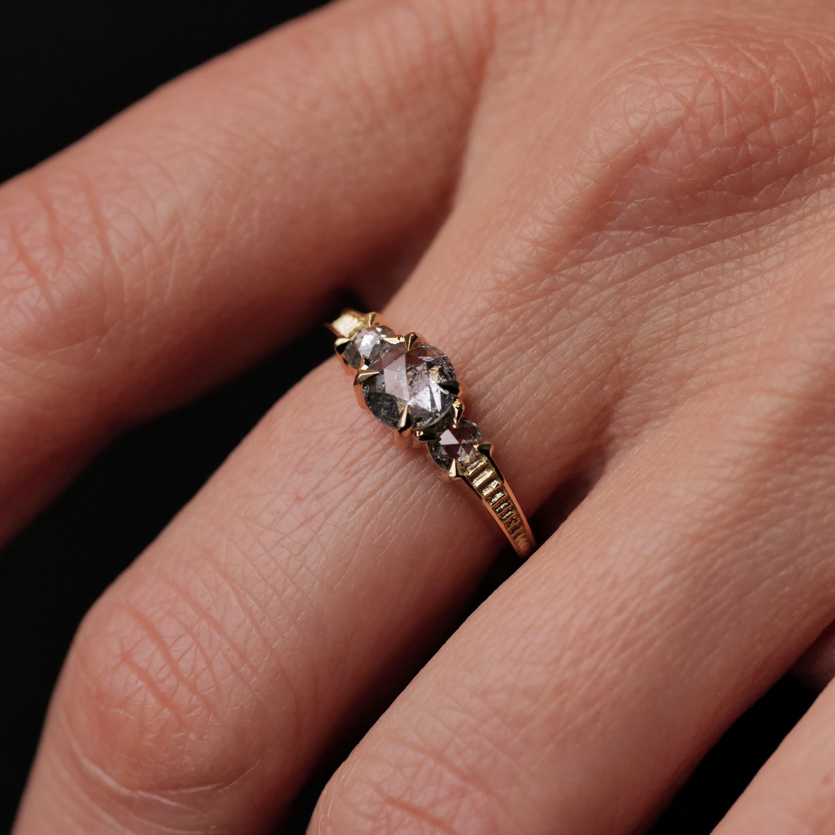The Classic 3 Stone Temple Ring by Fiat Lux features a 0.86ct salt & pepper diamond set in 18K gold.