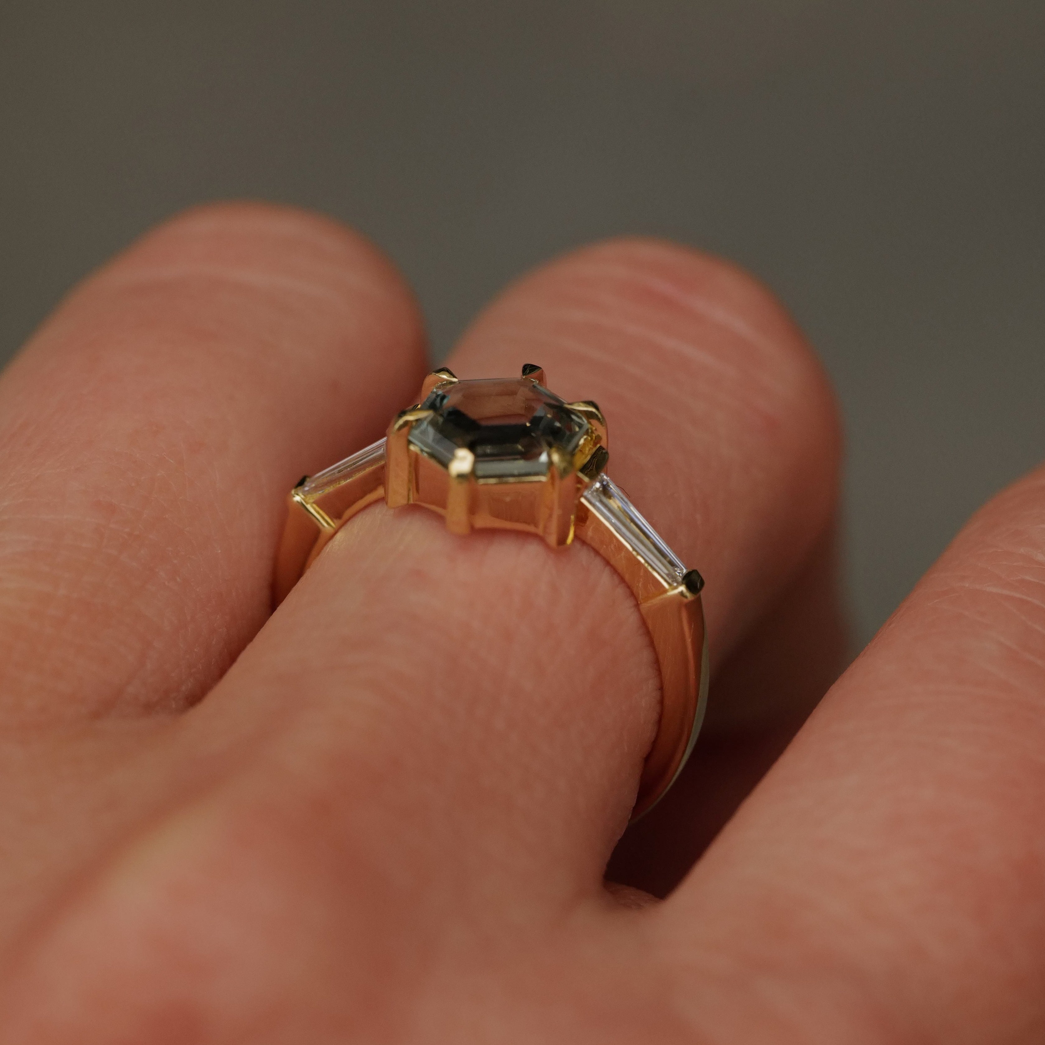 The Grande Calliope by Fiat Lux: a seafoam green hexagon sapphire ring with baguette diamonds in 18K gold.