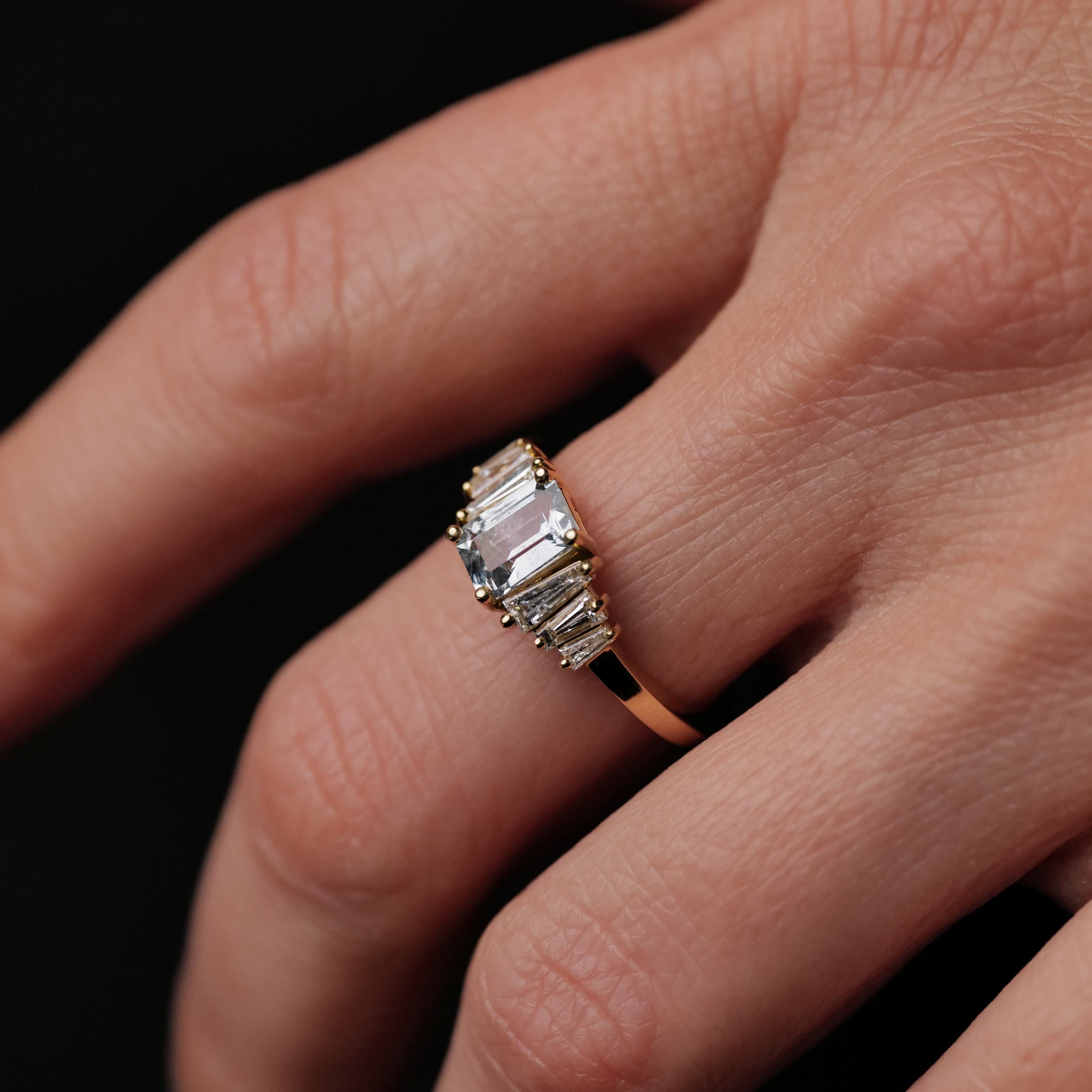 The Petite Calypso - Ice Blue Sapphire (1.16ct) ring by Fiat Lux shines against a black background.