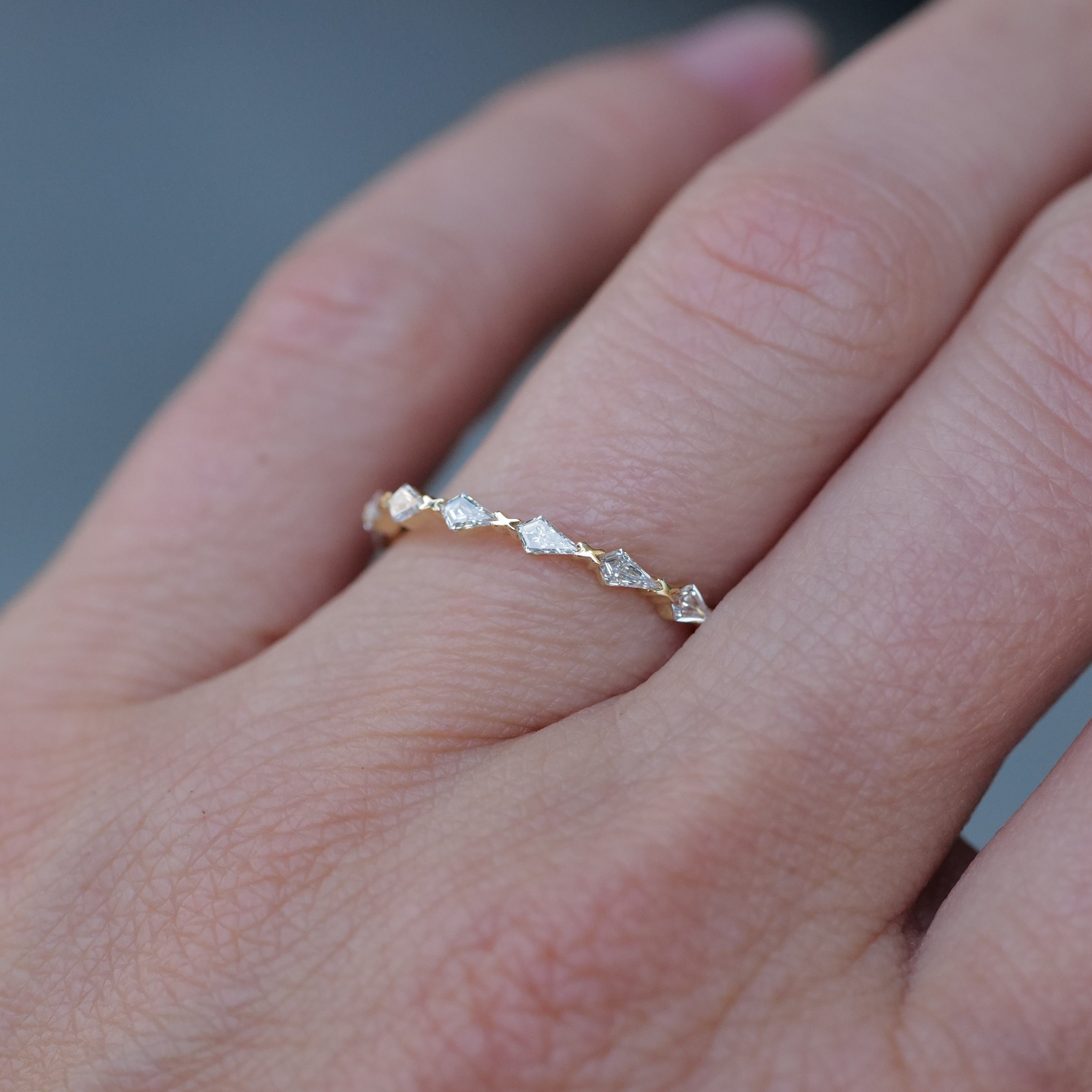 Fiat Lux Petite Infinity Kite Ring - White Diamond, 14K gold, shown close-up on a persons finger.