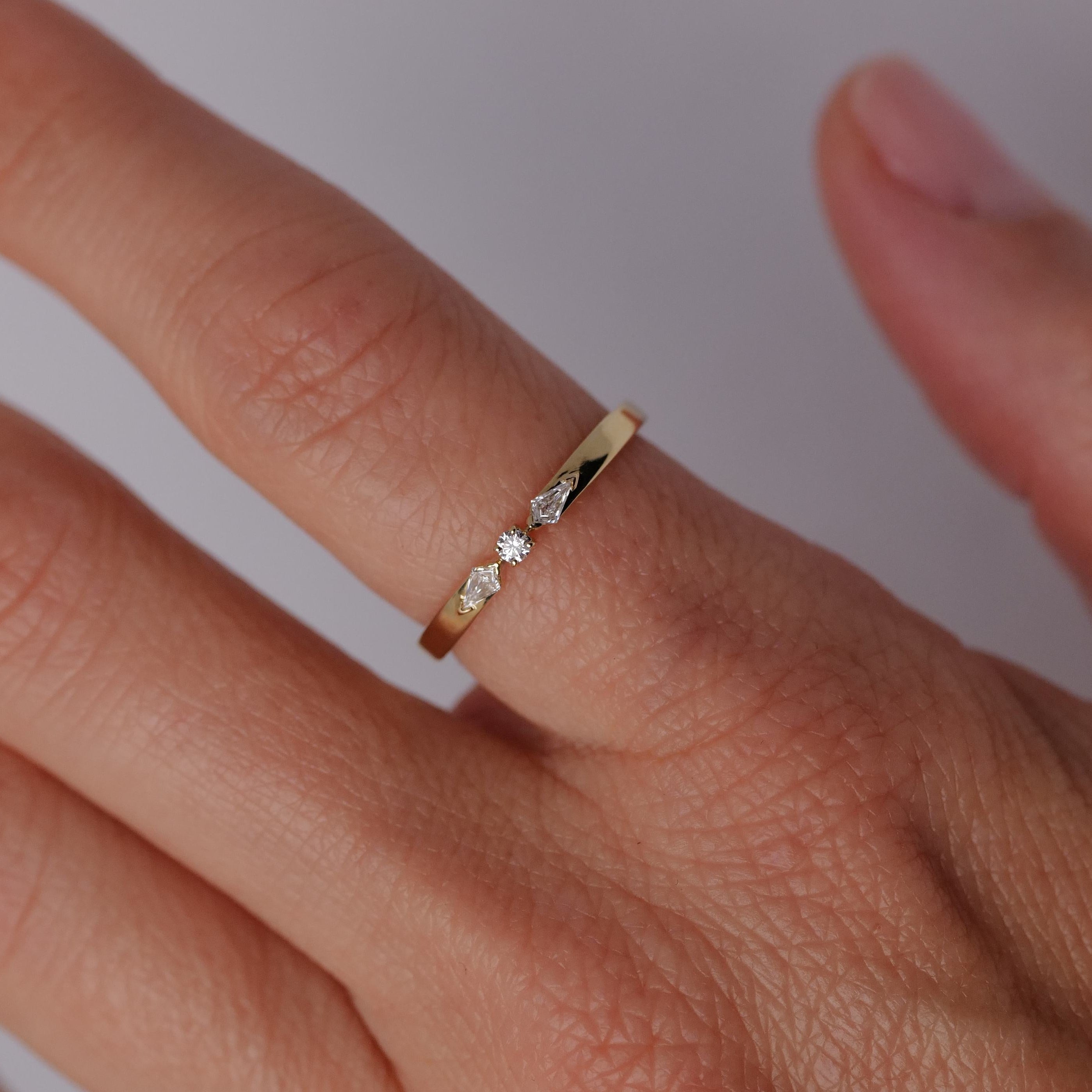 The Fiat Lux Petite Nova Ring, in 14K gold, showcases three small diamonds against a light background.