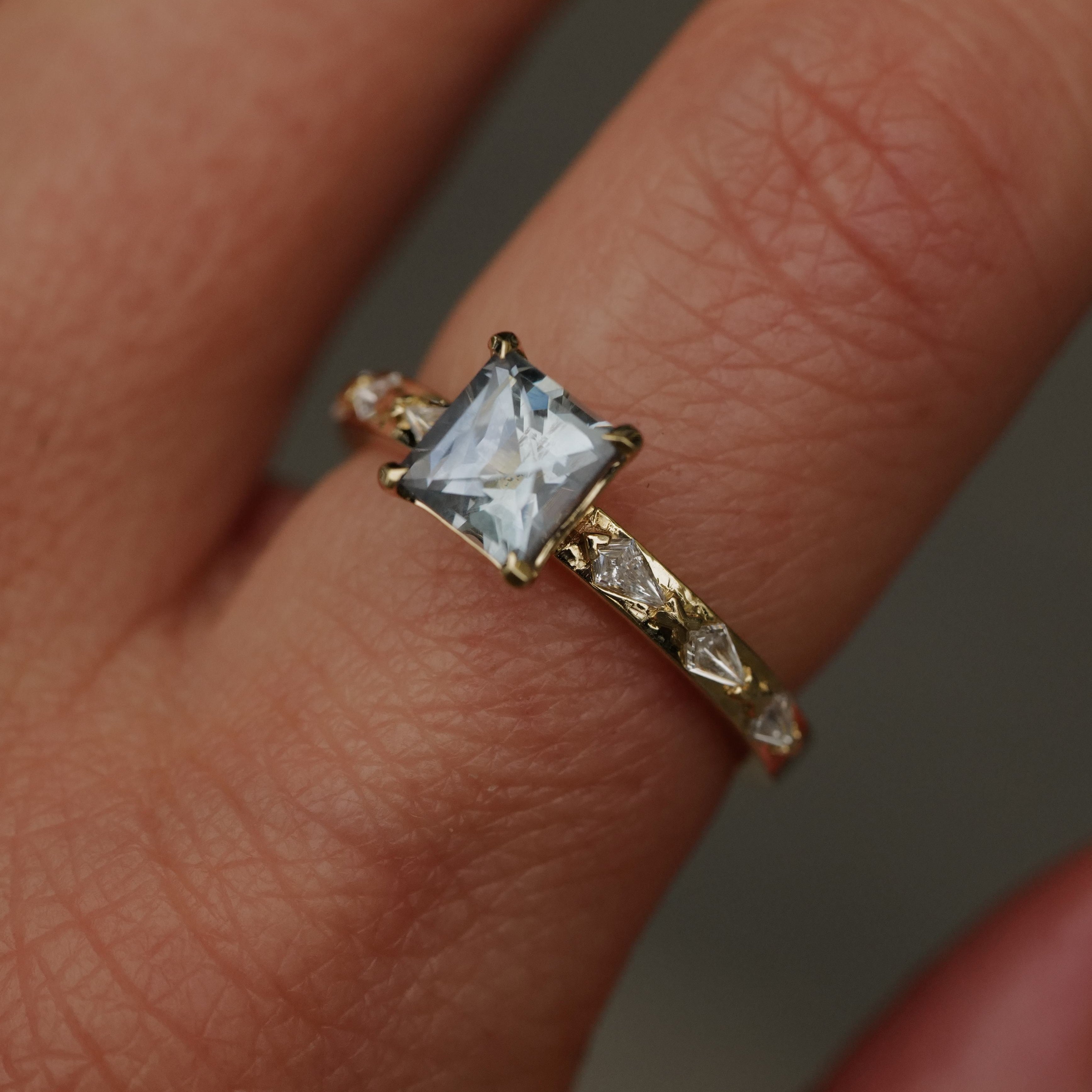 Fiat Lux Classic Theia Ring: 14K gold, aqua sapphire (1.41ct), kite-cut diamonds, worn with elegance.