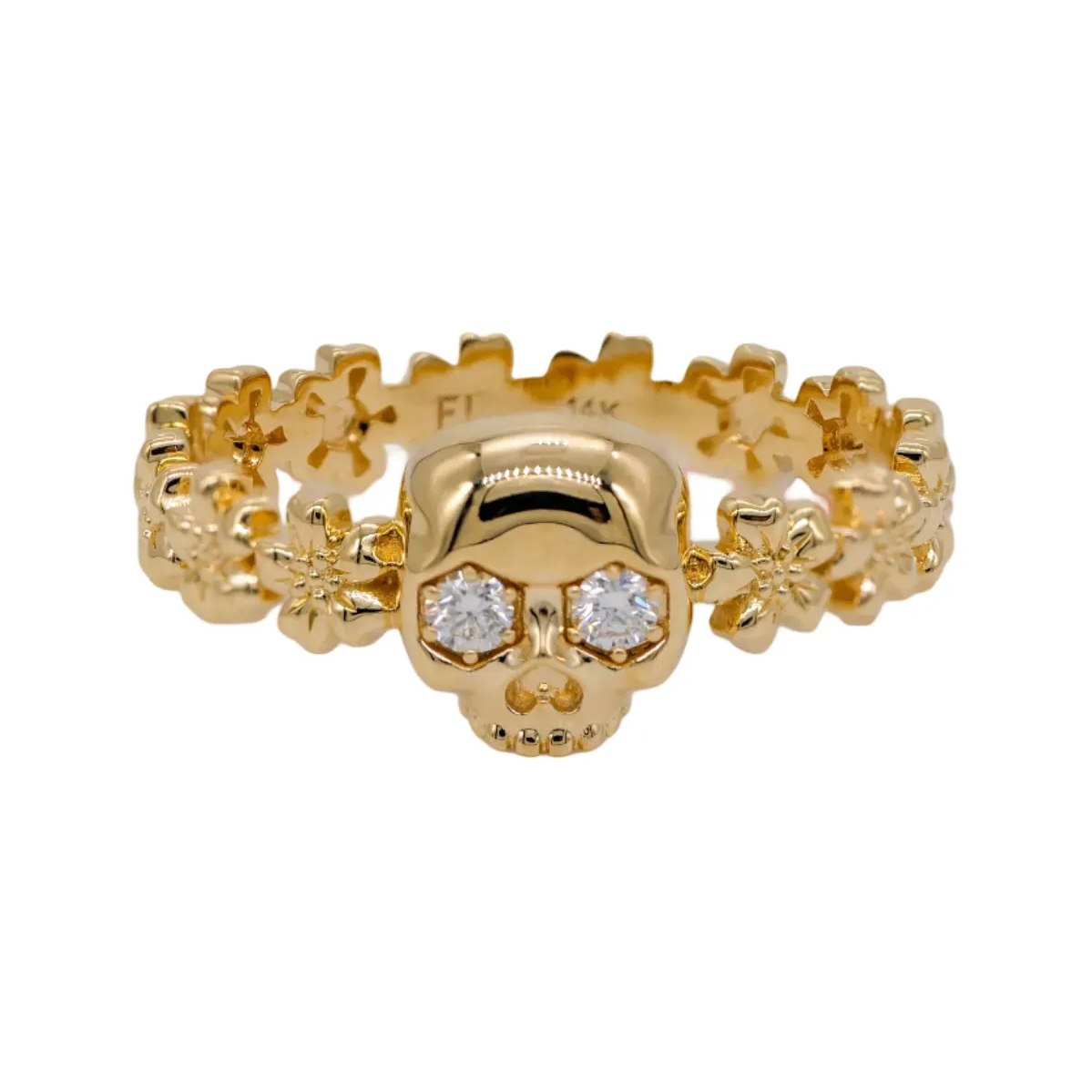 The Fiat Lux Forget Me Not Skull Ring features diamond eyes and floral details in 14k gold.