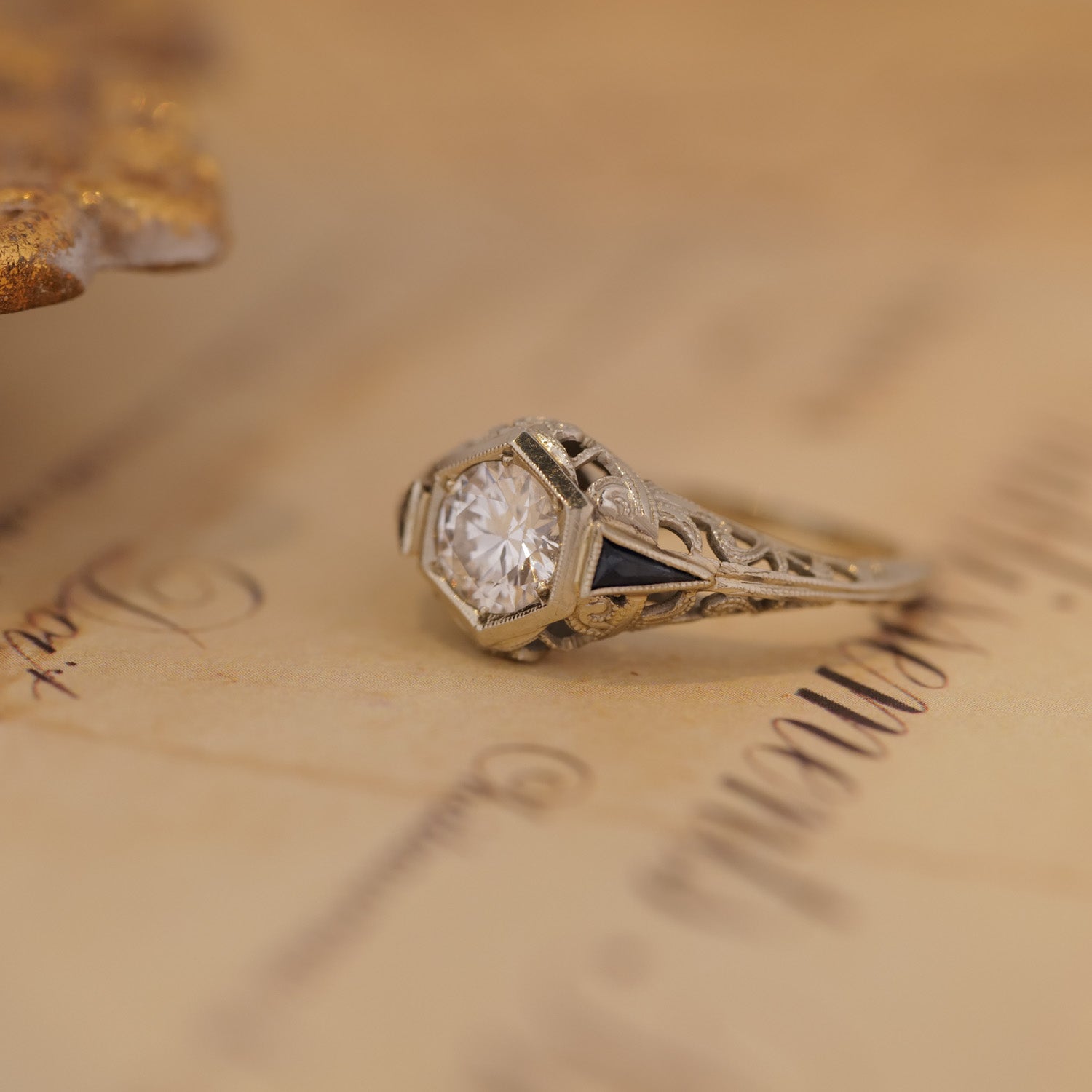 Vintage Art Deco Botanical Hexagon Ring sits atop vintage handwritten paper.