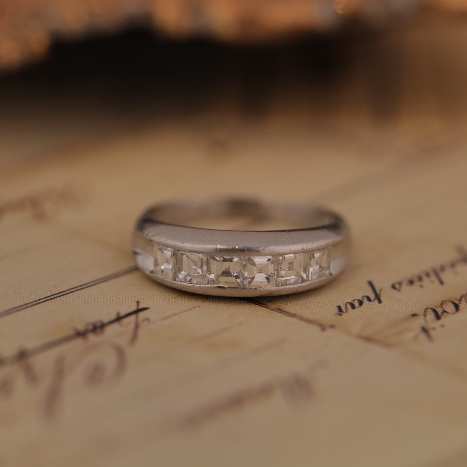 Silver ring with diamonds on an old document