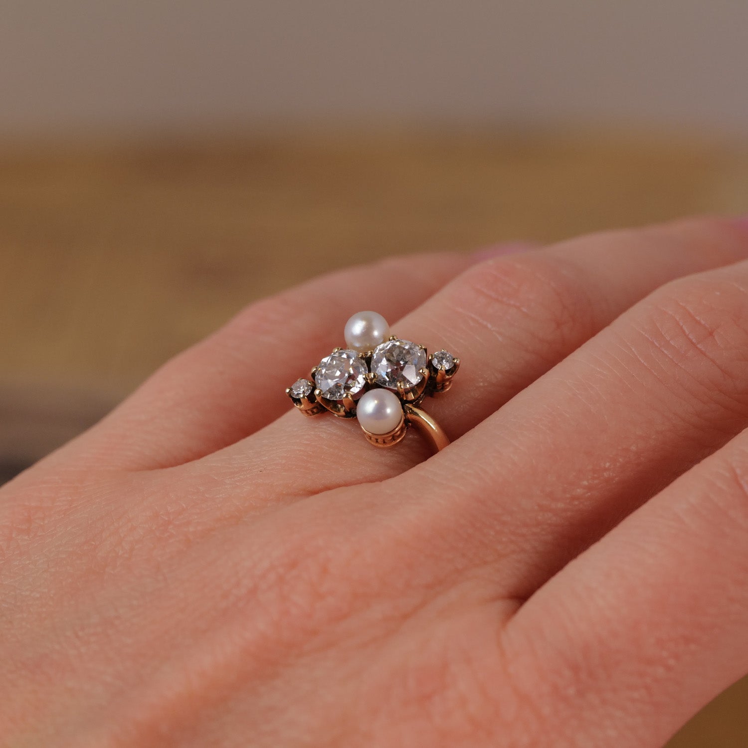 Vintage Double Pearl Diamond Ring by Vintage featuring antique pearls and an Old European-cut diamond on the finger.