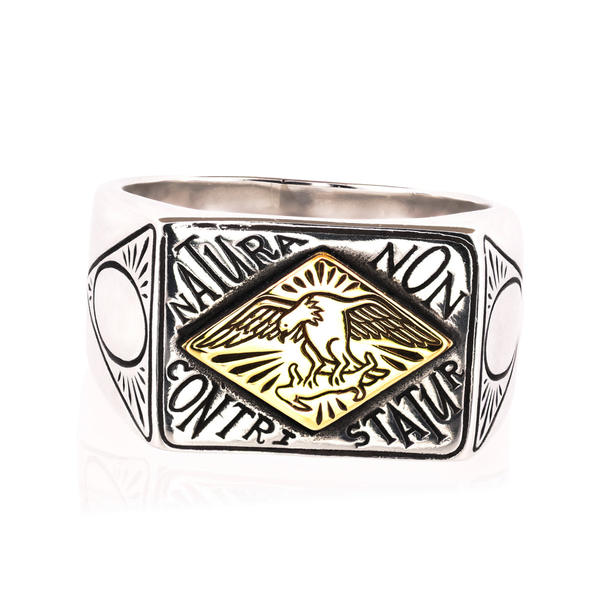 A silver-toned signet ring featuring a central gold diamond-shaped emblem with an eagle, surrounded by the Latin phrase 'Natura non contraria statuit'.