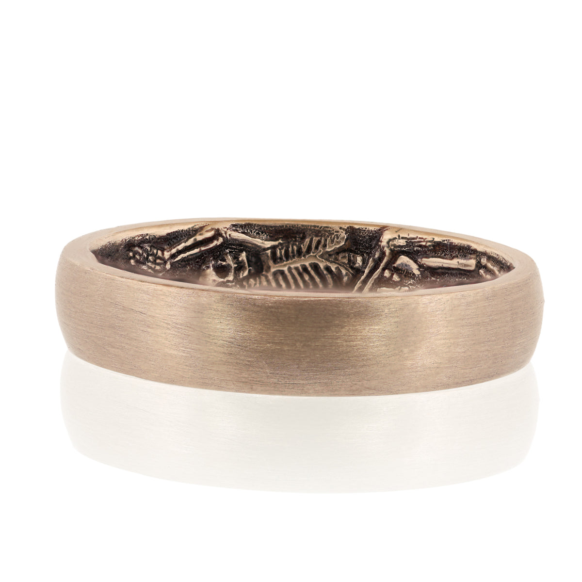 Secret Skellies Ring - Soft Domed by DMD Metal, features a raised skeleton design on bronze, shown on a white background.
