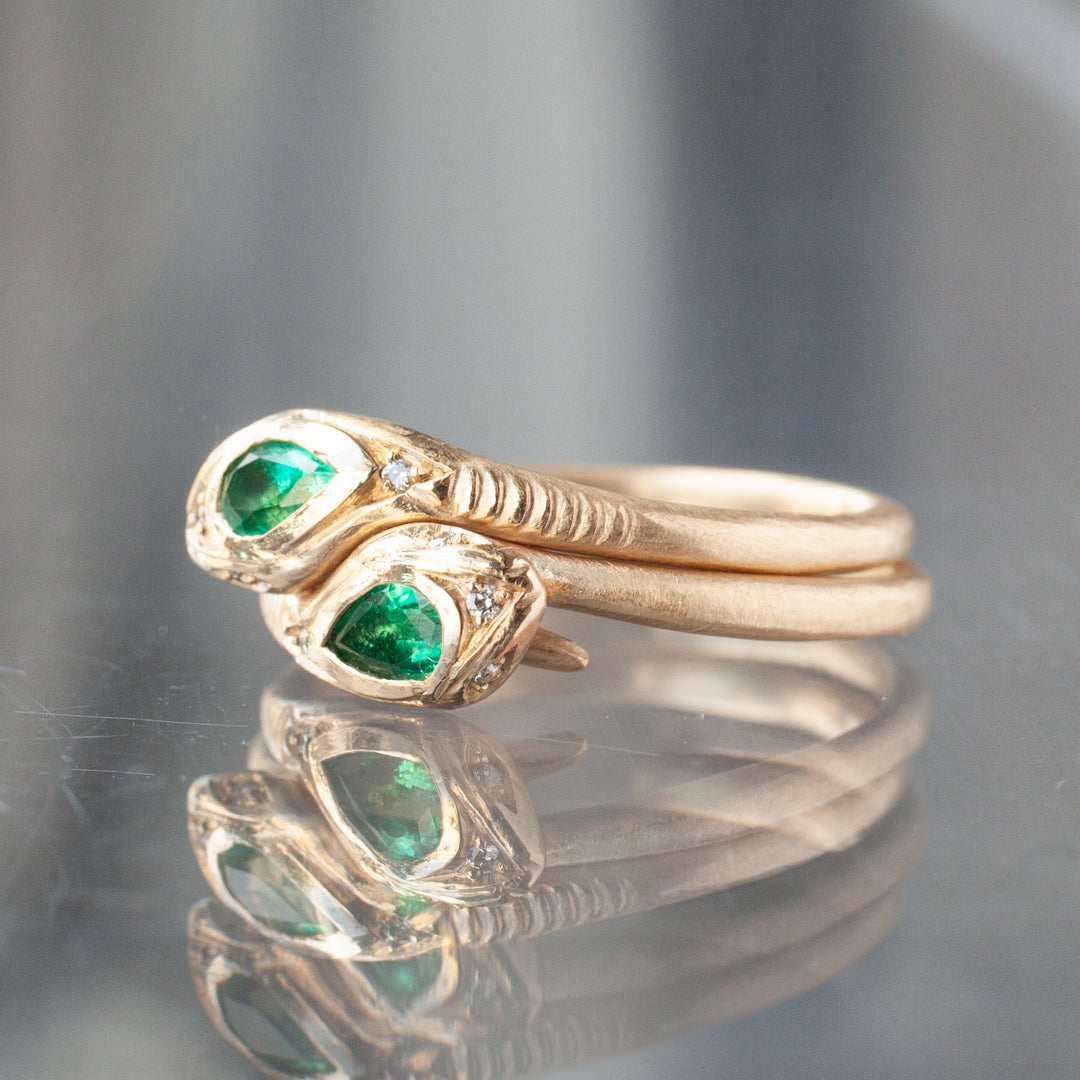 Victorias Fede Ring - Emerald Pear by Daisy San Luis: 14K gold ring with dual emerald gems, mirrored snake motifs.
