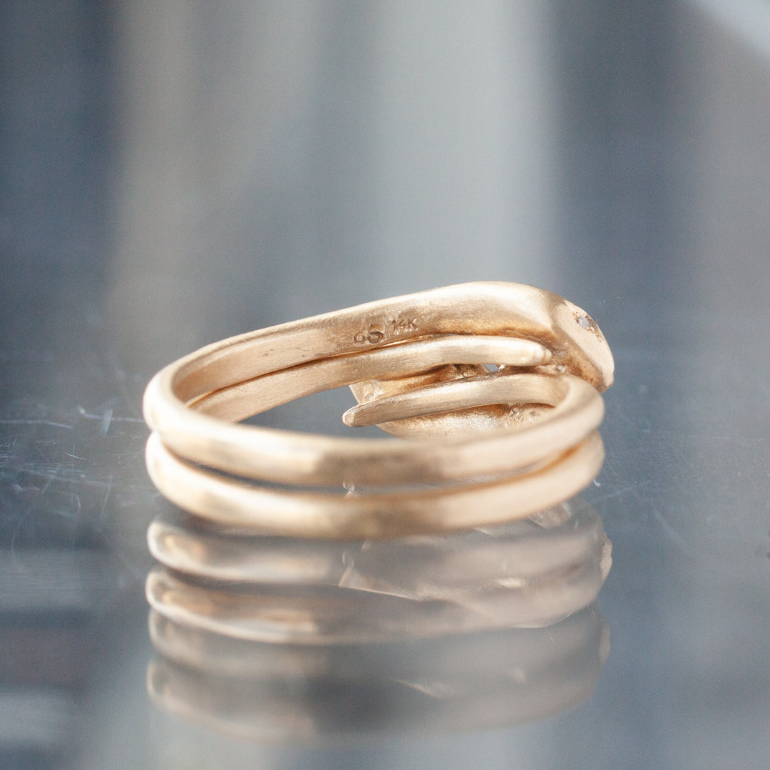 Victorias Fede Ring - Emerald Pear by Daisy San Luis: a 14K gold ring with an elegant coiled design and emerald detail.