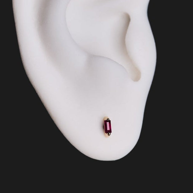 Fiat Lux Escalier Single Stud—colored gem 14K gold earring shown on a white ear sculpture against a black background.
