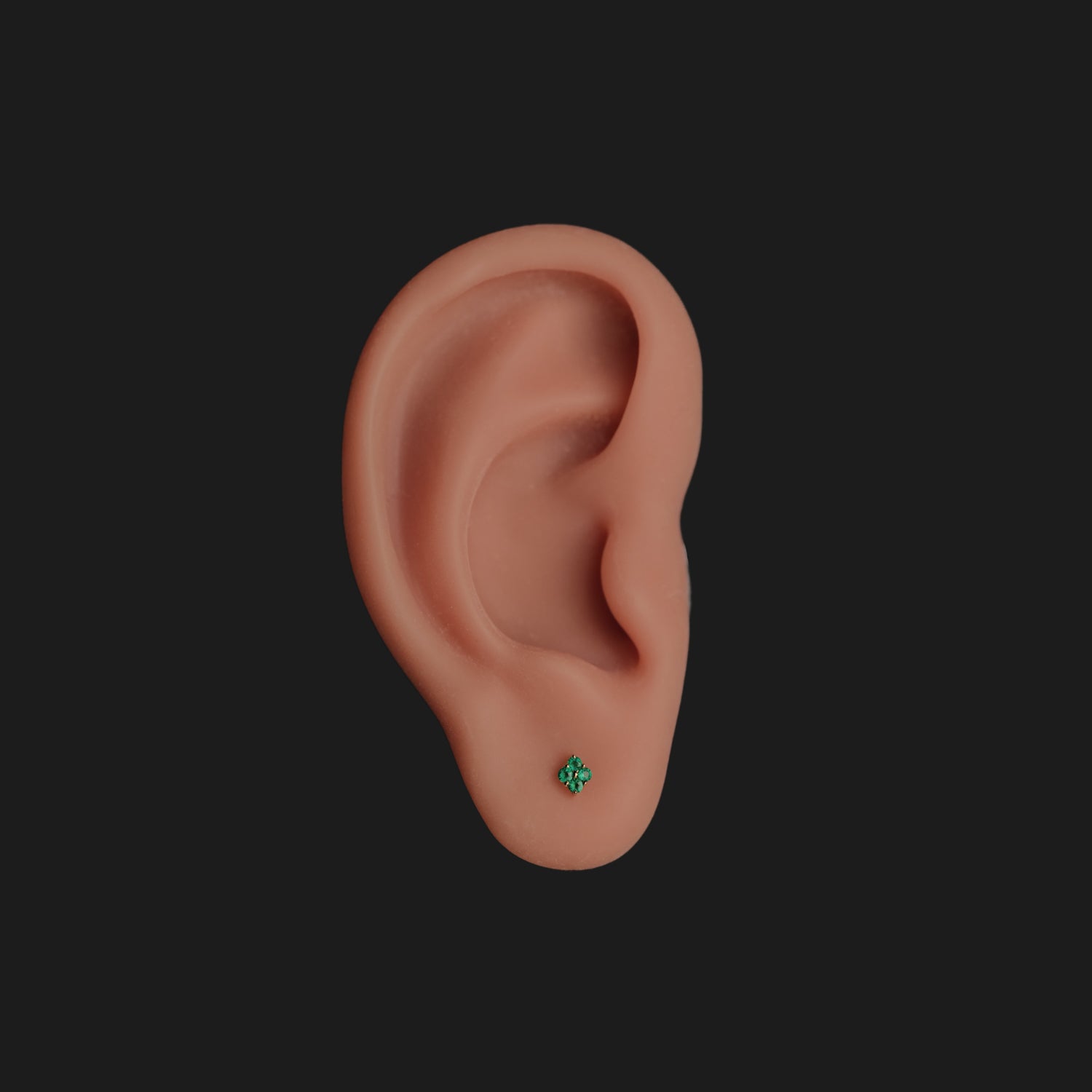A model ear wears the Grande Sirius Stud - Colored (1.5mm) by Fiat Lux, set against a black background.