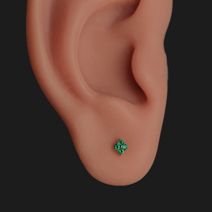 A model ear wears the Grande Sirius Stud - Colored (1.5mm) by Fiat Lux, set against a black background.