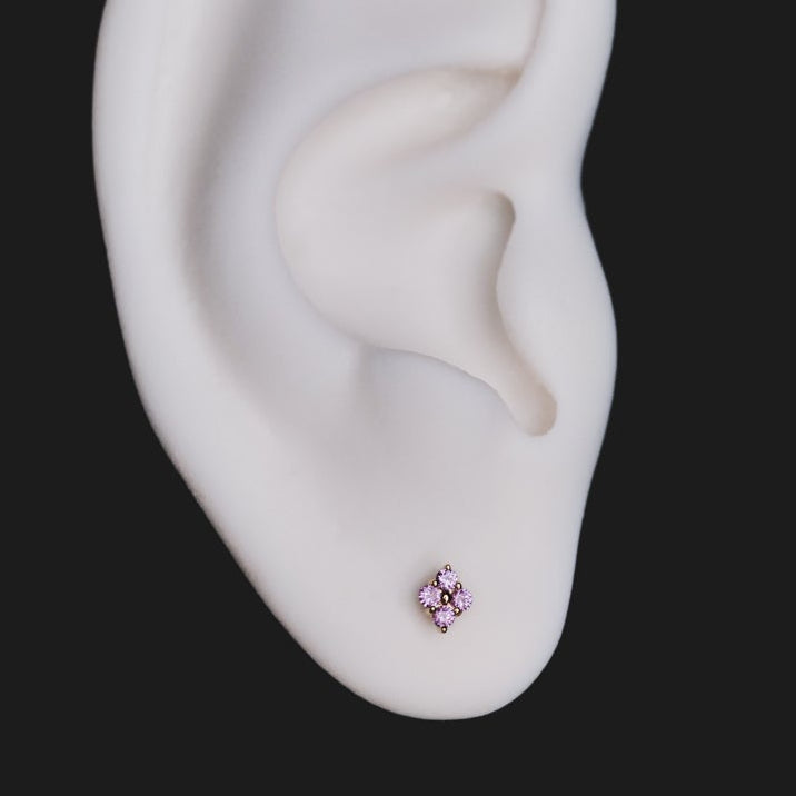 A white model ear with Fiat Lux Grande Sirius Stud (1.5mm, pink) flatback earring on a black background.